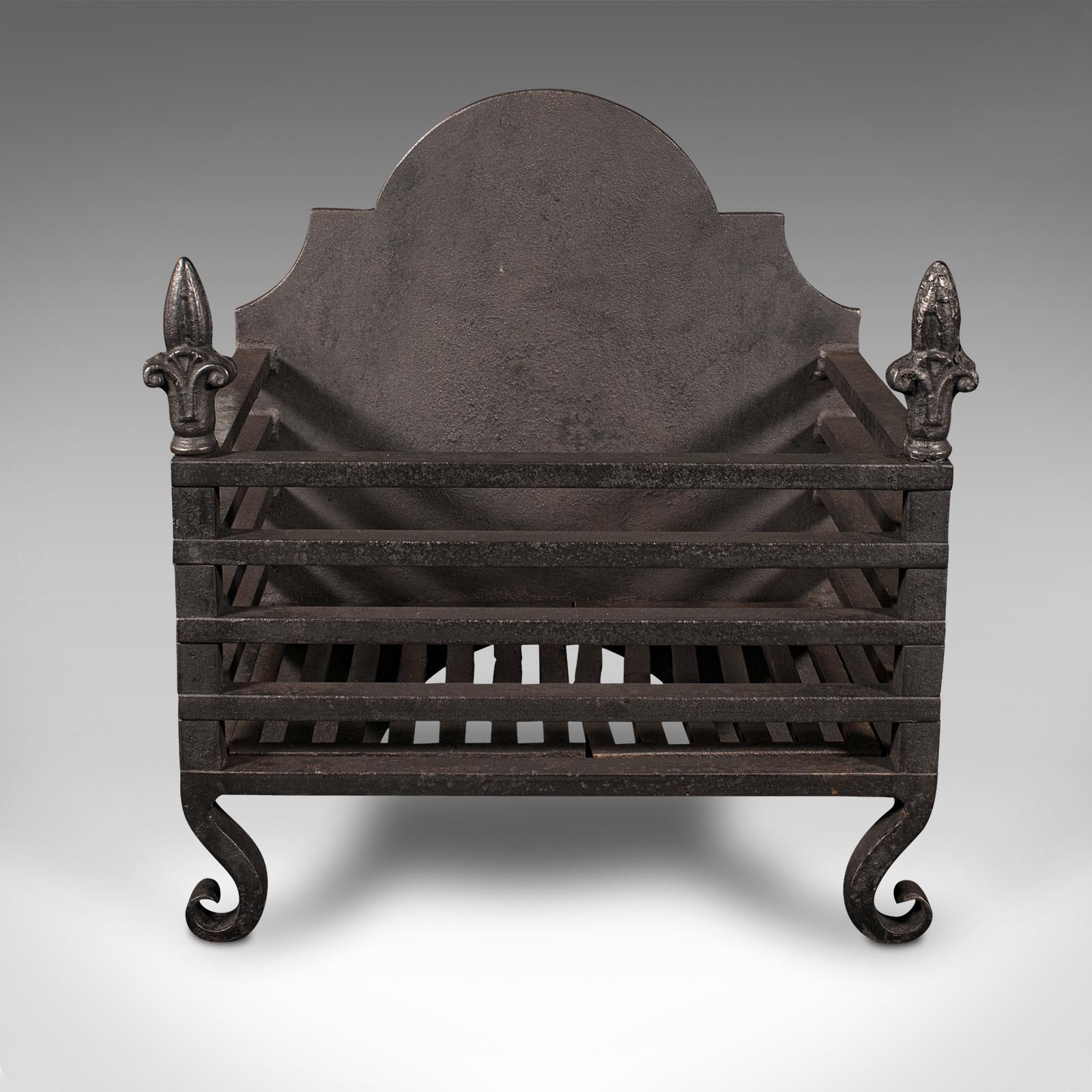 This is an antique fire grate. An English, cast iron fireplace basket, dating to the late Victorian period, circa 1900.

Appealing, self-contained grate with ideal proportion for the smaller hearth
Displays a desirable aged patina and in good