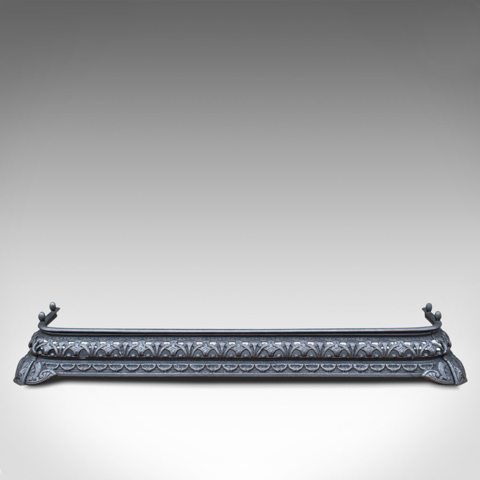 This is an antique fire kerb and companion tongs. An English, iron fireside set, dating to the Victorian period, circa 1850.

An appealing, Victorian fireside set
Displays a desirable aged patina
Fire kerb crafted from cast iron
Decorative,