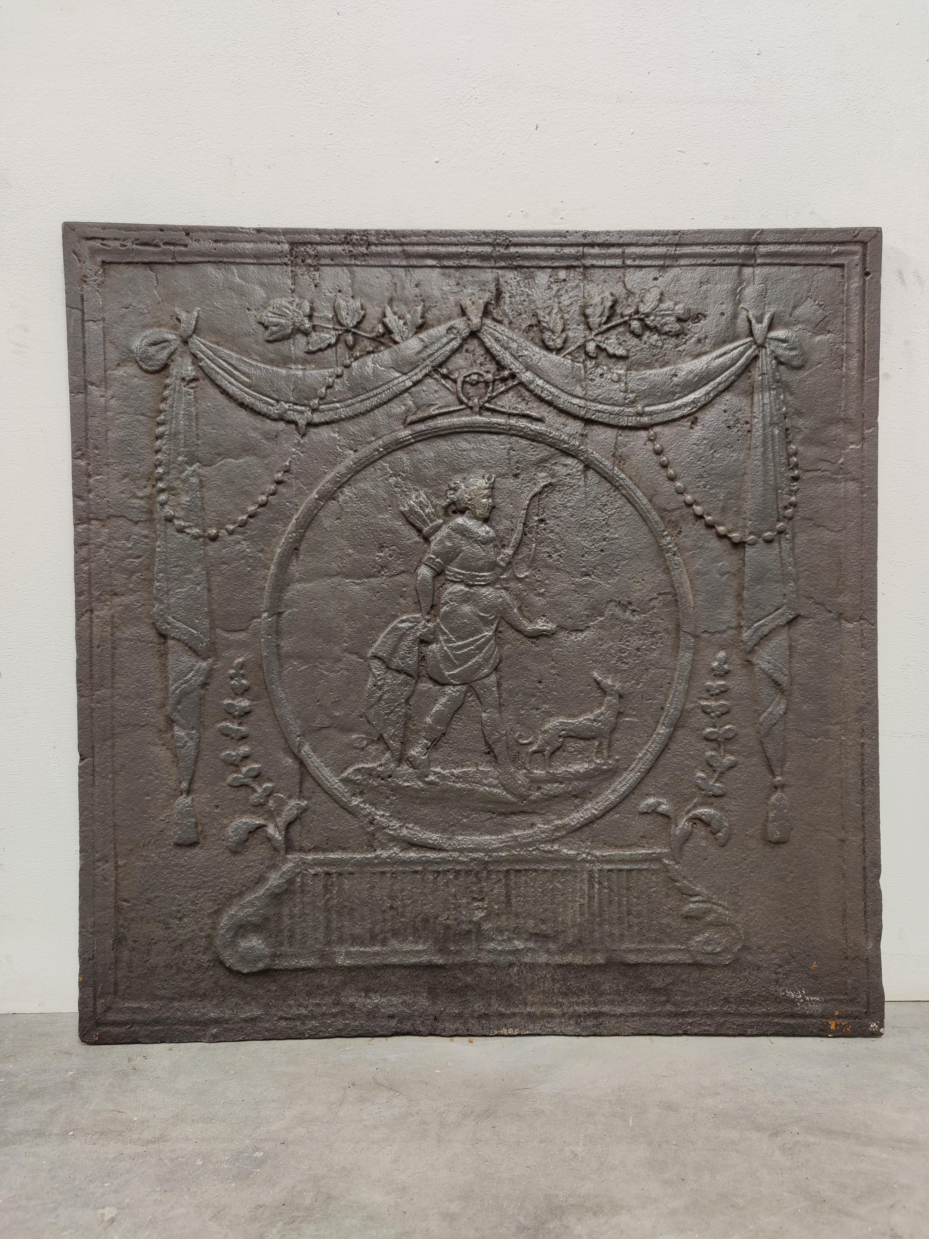 Man with bow and arrow accompanied by a dog, on the hunt.

A great square cast iron antique fireback displaying a man with bow and arrow.
Great condition, can be used in a real gas or log fire.
Very decorative piece.
84 lbs / 38 kg.

   
  