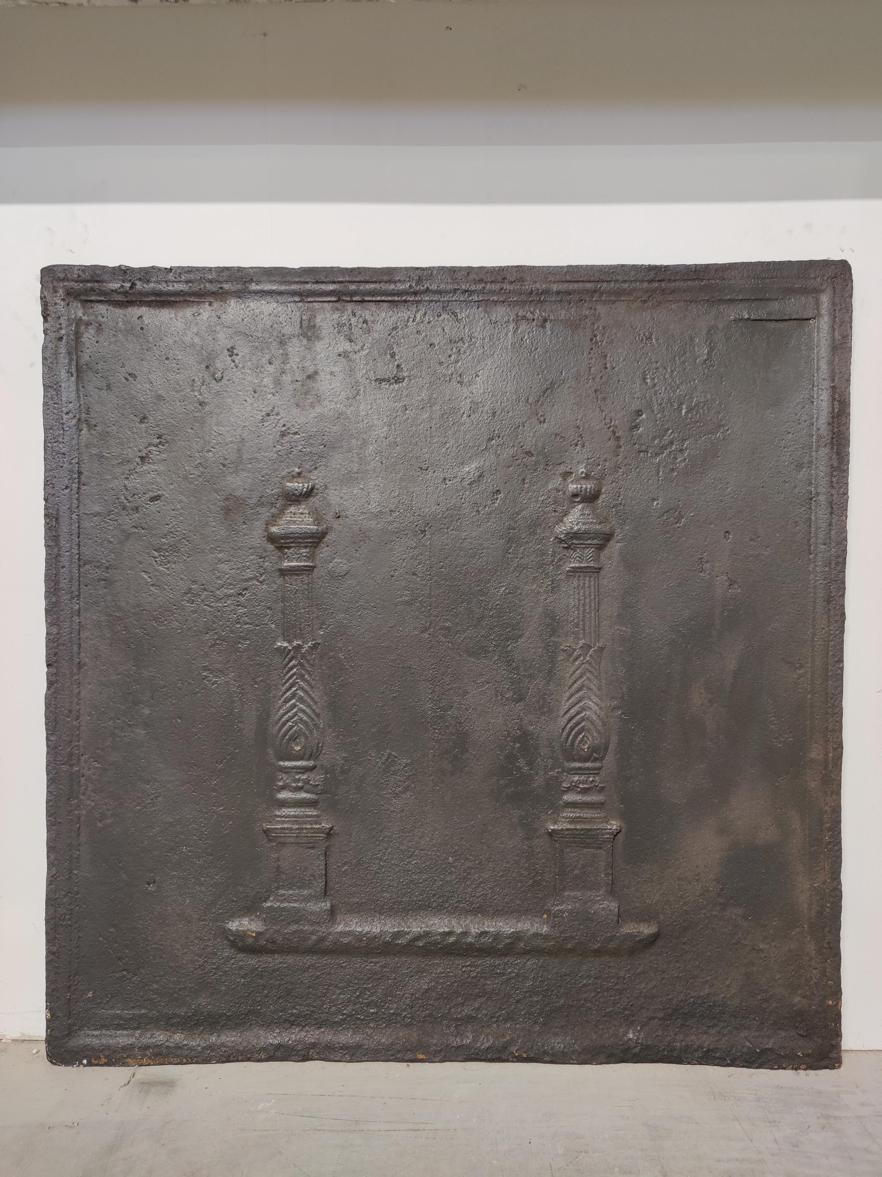 Antique fireback / backsplash, profiled pillars.

Nice square cast iron antique fireback displaying two nicely decorated profiled pillars.
Great condition, can be used in a real gas or log fire.
Very decorative piece.
126 lbs / 57 kg.