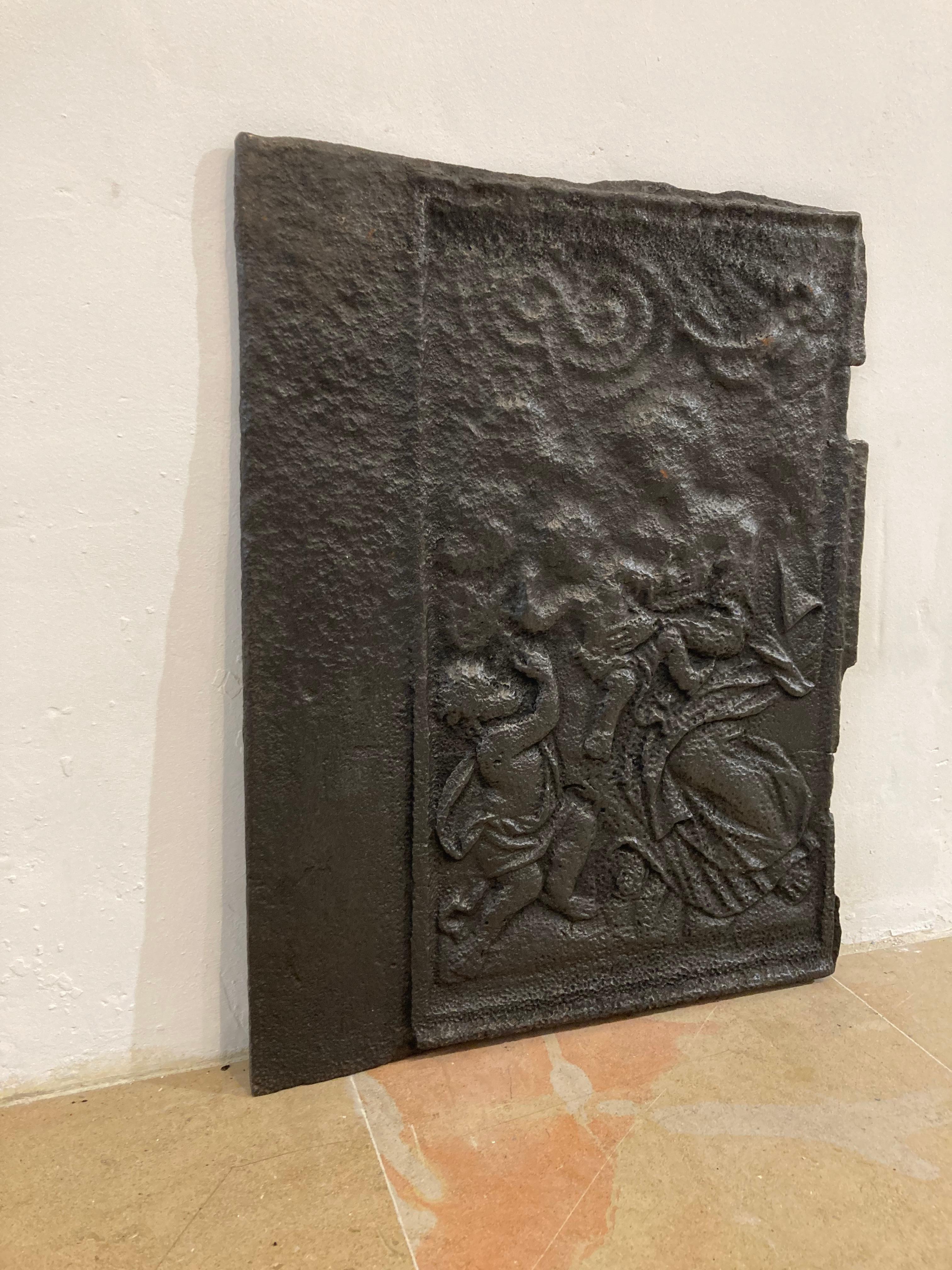 This antique fireback is in seriously used condition.
It displays caritas which means unlimited loving-kindness to all others or 