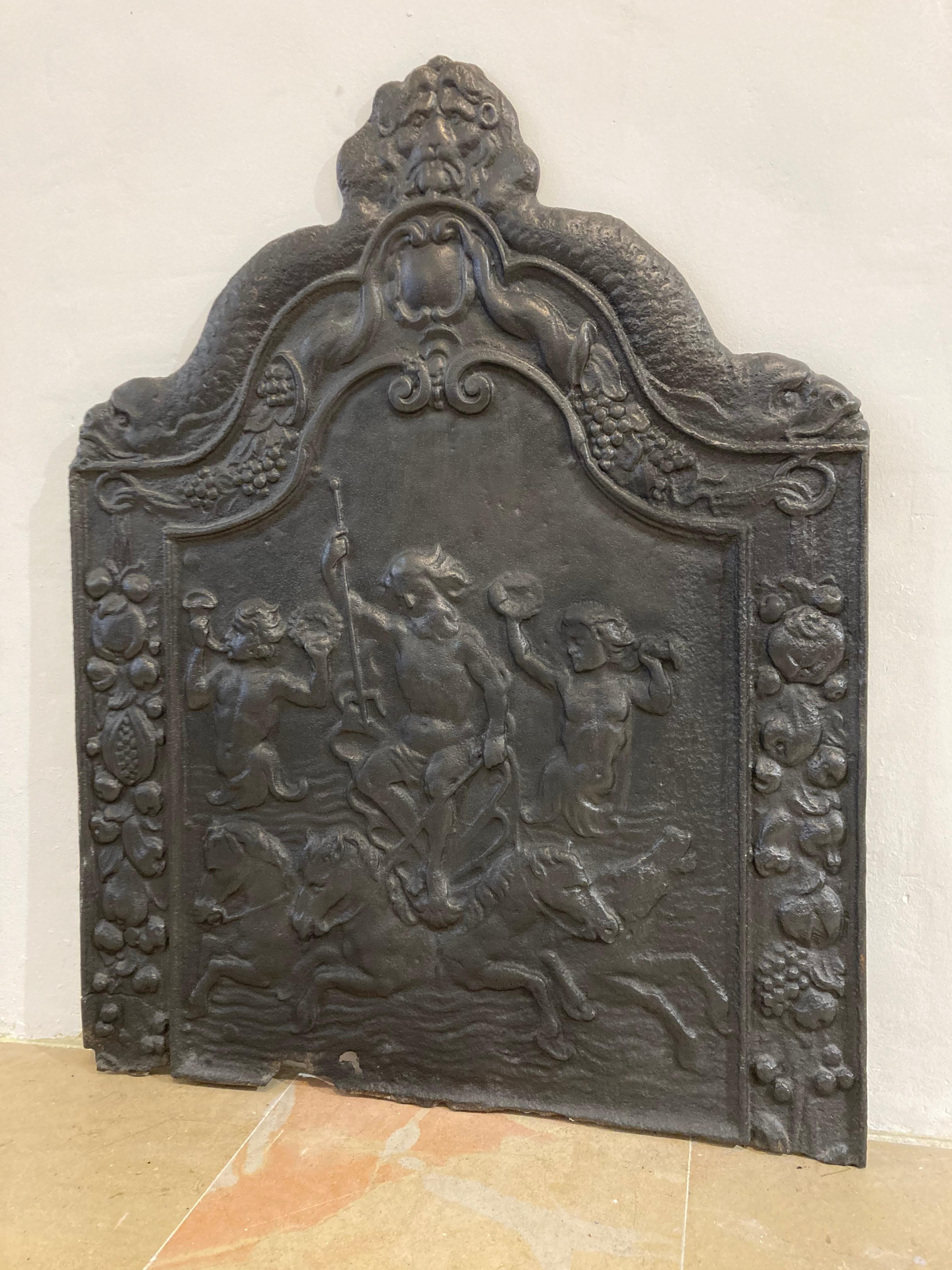 Lovely tall and decorative fireback with a depiction of Poseidon holding trident, the sea, four horses and cherubs holding trumpet.

Bottom is rough and has a repair, overall great looking and impressive piece.