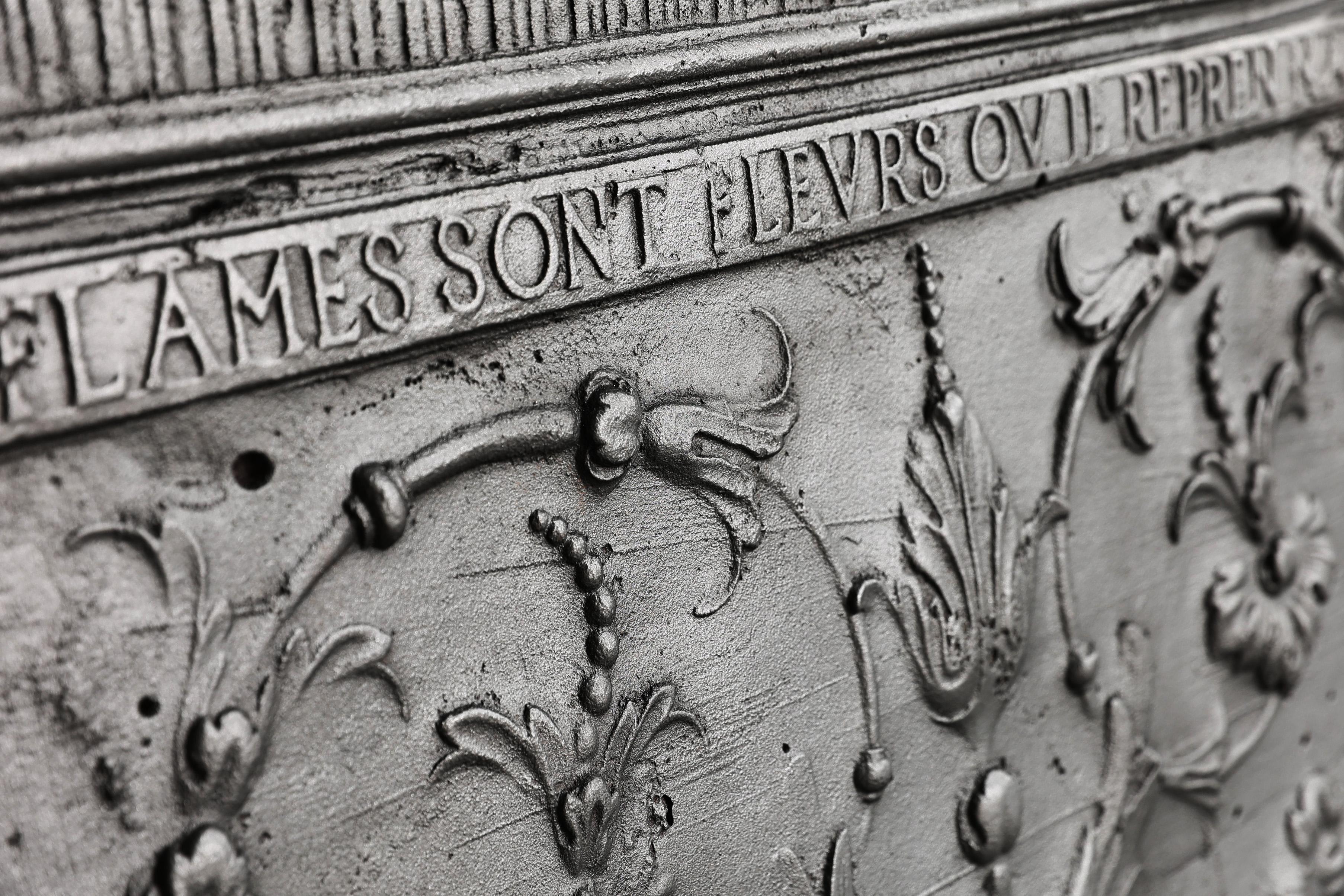 Very beautiful fireback from the early 18th century of cast iron. This fireback is special because of its text and the elegant ornaments. 