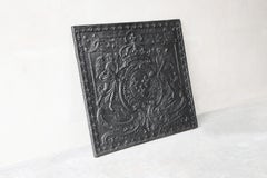 Antique fireback from cast iron from the early 19th century