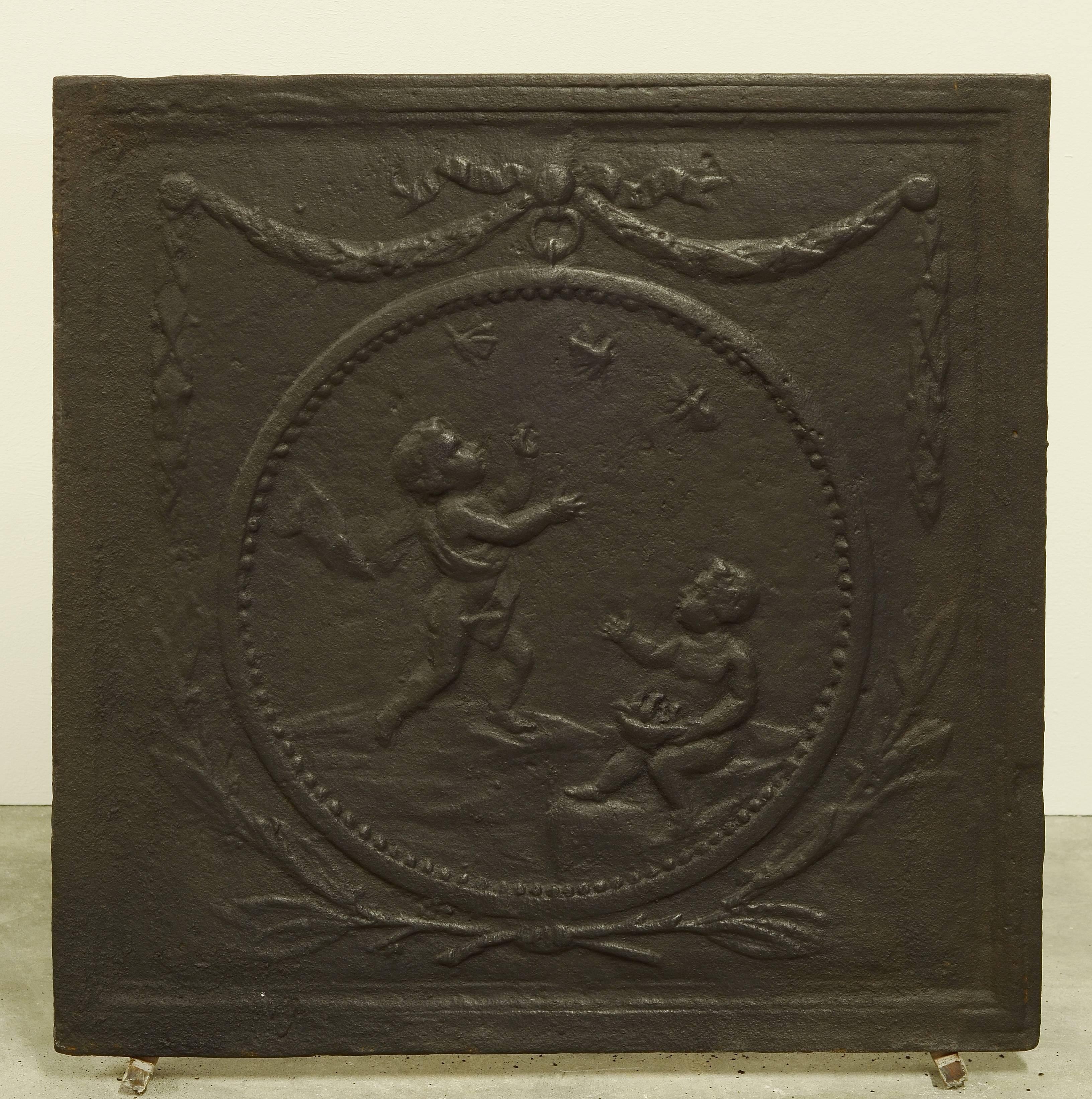Nice square and decorative cast iron fireback with cupids throwing 