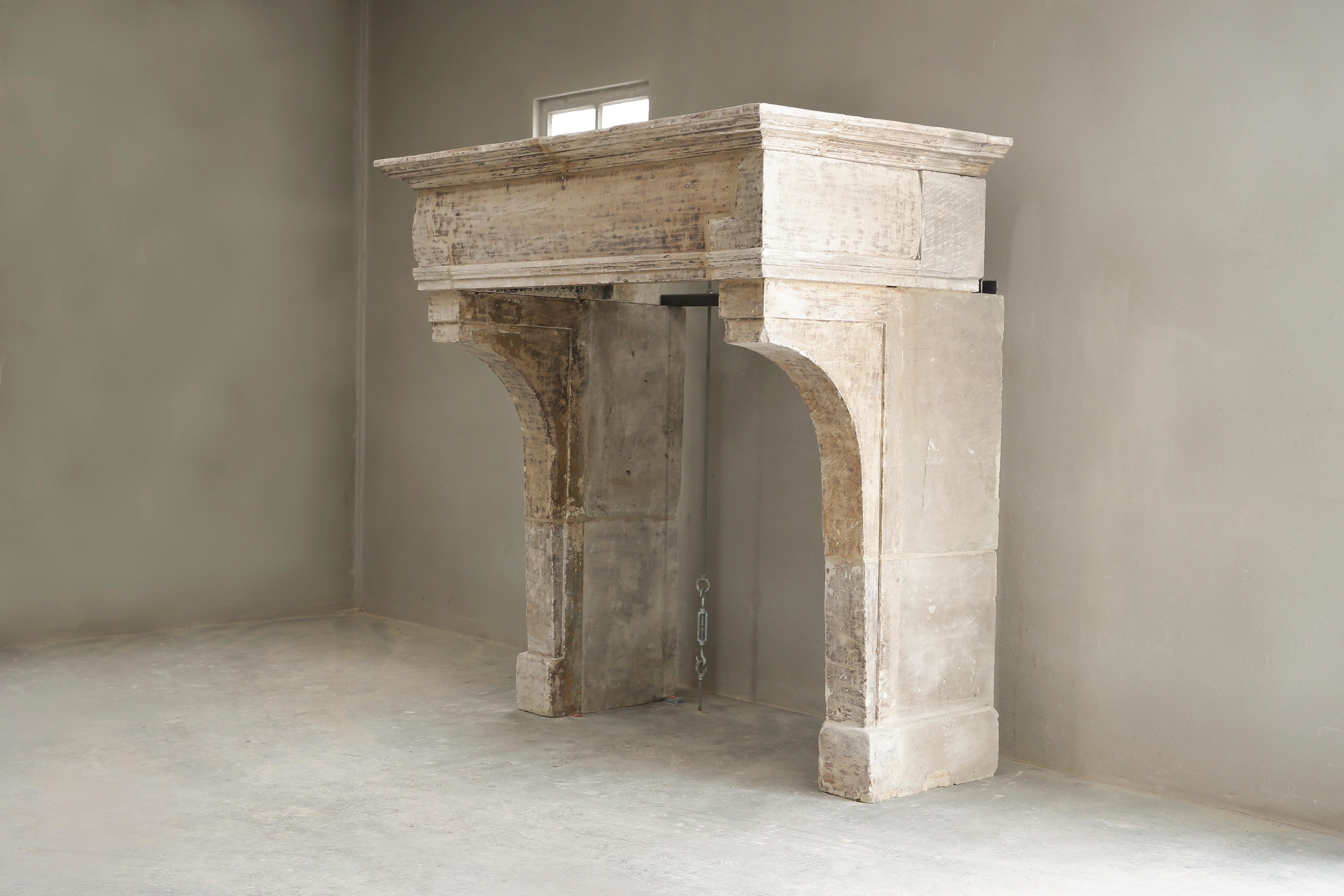Beautiful robust antique chimney of French limestone from the 19th century. The chimney has a beautiful patina and a very wide front part, that is making this mantelpiece unique in its kind. Because of the moulure (frame), big top and obelisque