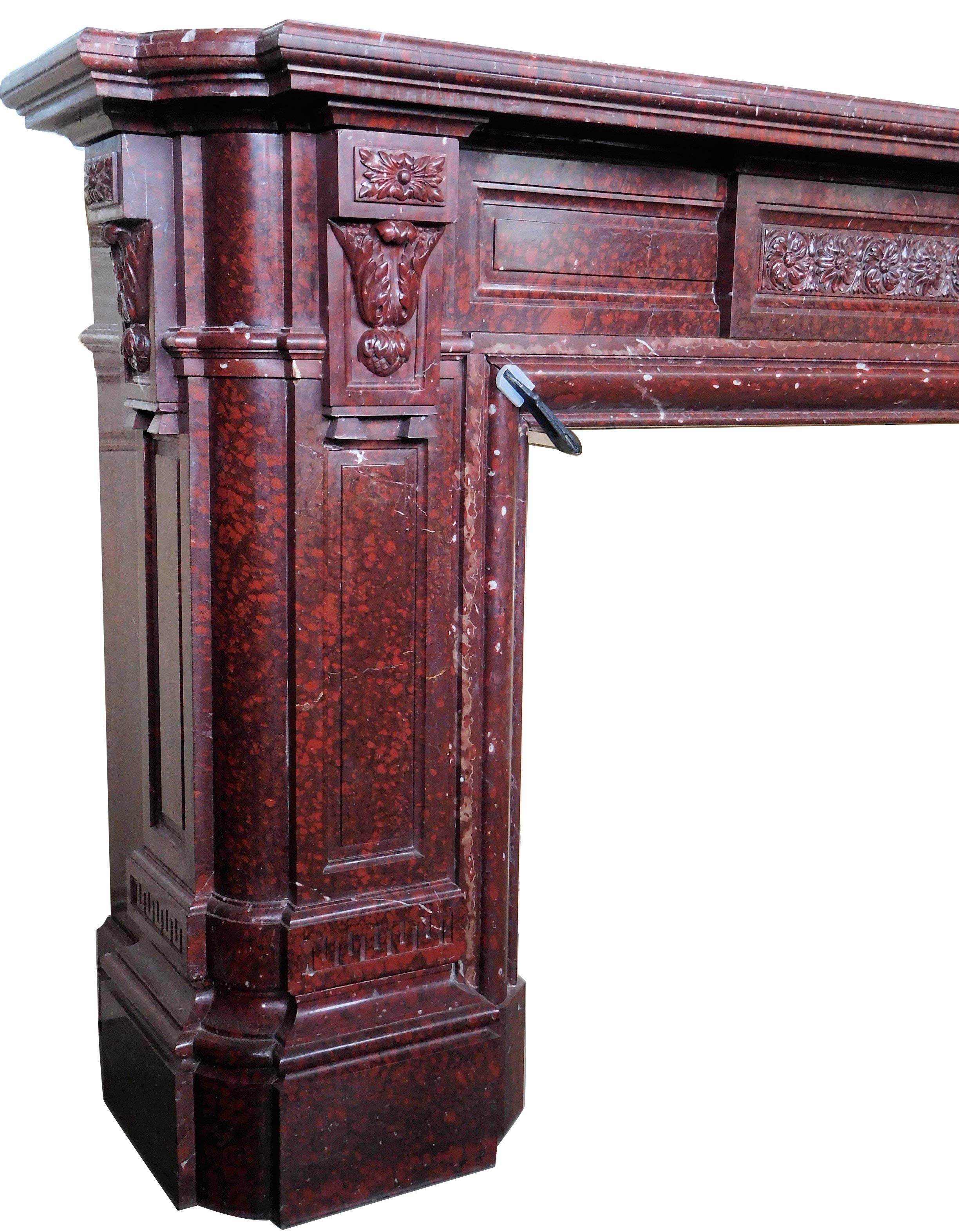 This impressive fireplace was made circa 1850 from the highly-valued Griotte Rouge marble.
This mantel features many fine carvings and various ornamentation, all over the front and jambs.
The jambs are carved both sides. This beautiful piece of