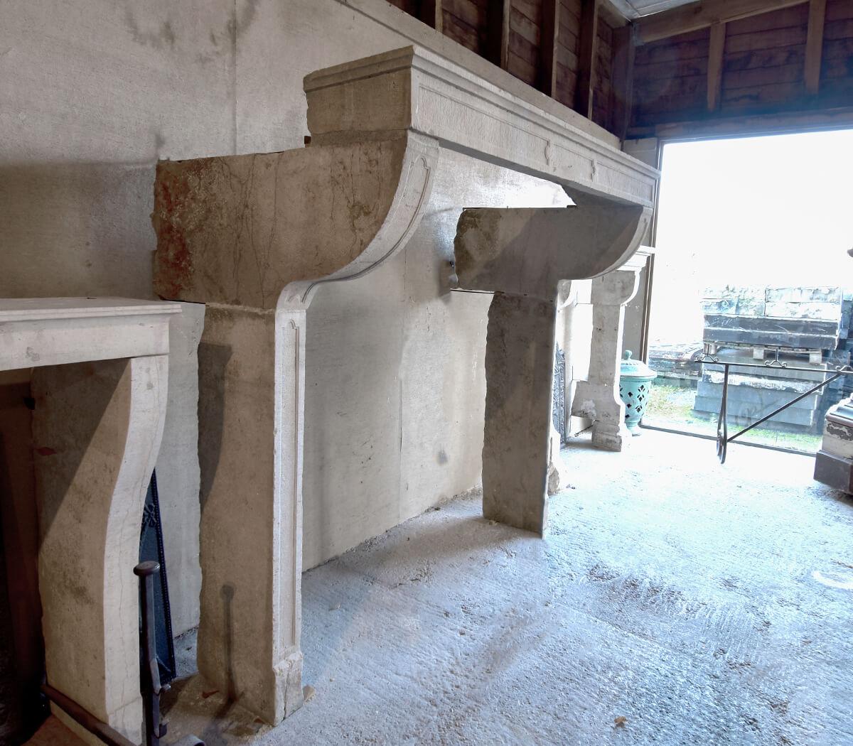 Original antique French sandstone fireplace mantel from the 19th Century. Model is large but slim with very nice carvings.