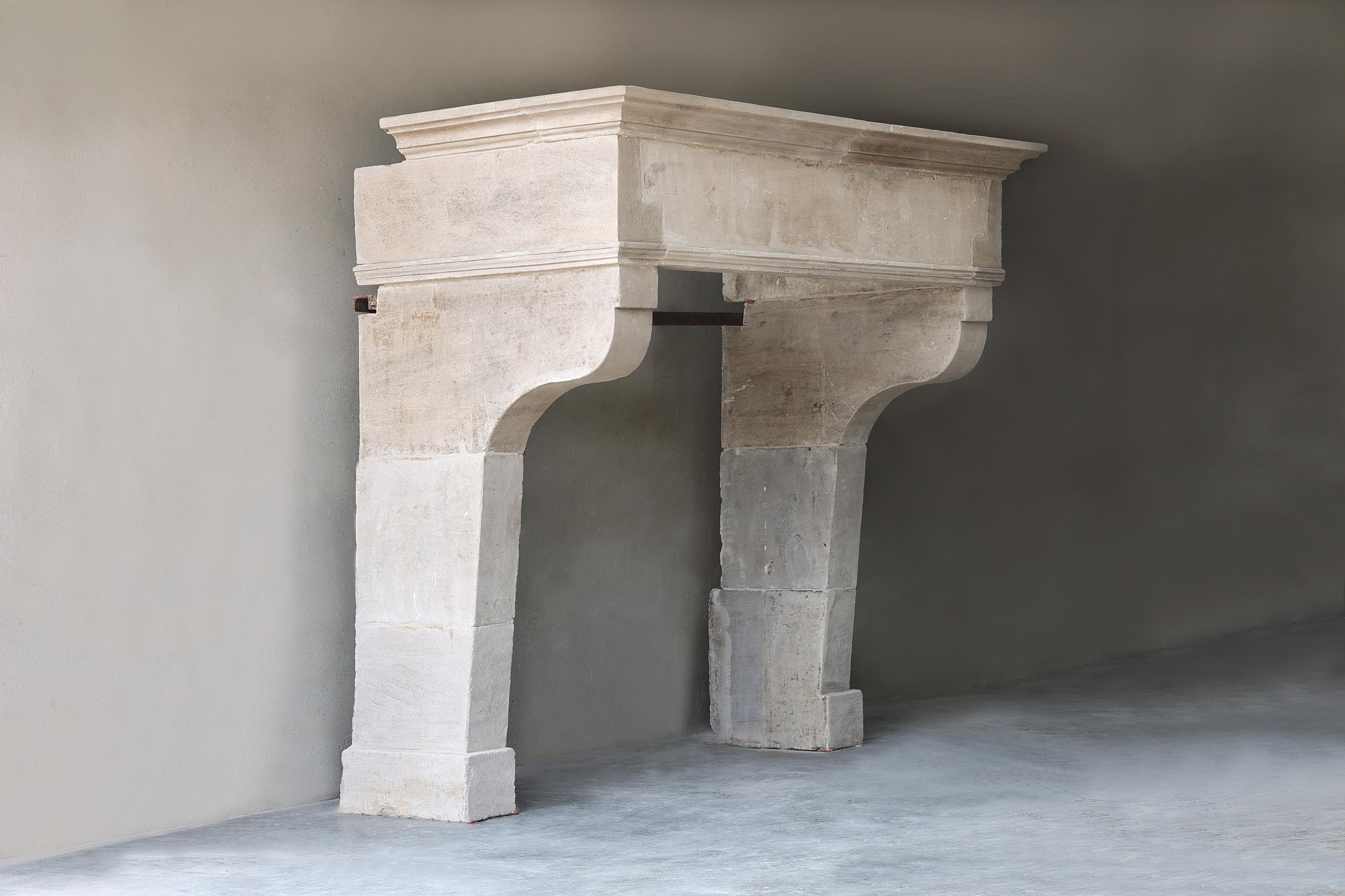Beautiful antique castle mantelpiece made of French limestone from the 19th century! This beautiful fireplace has a wide top with slightly curved legs. A rustic mantle with a historic look.
