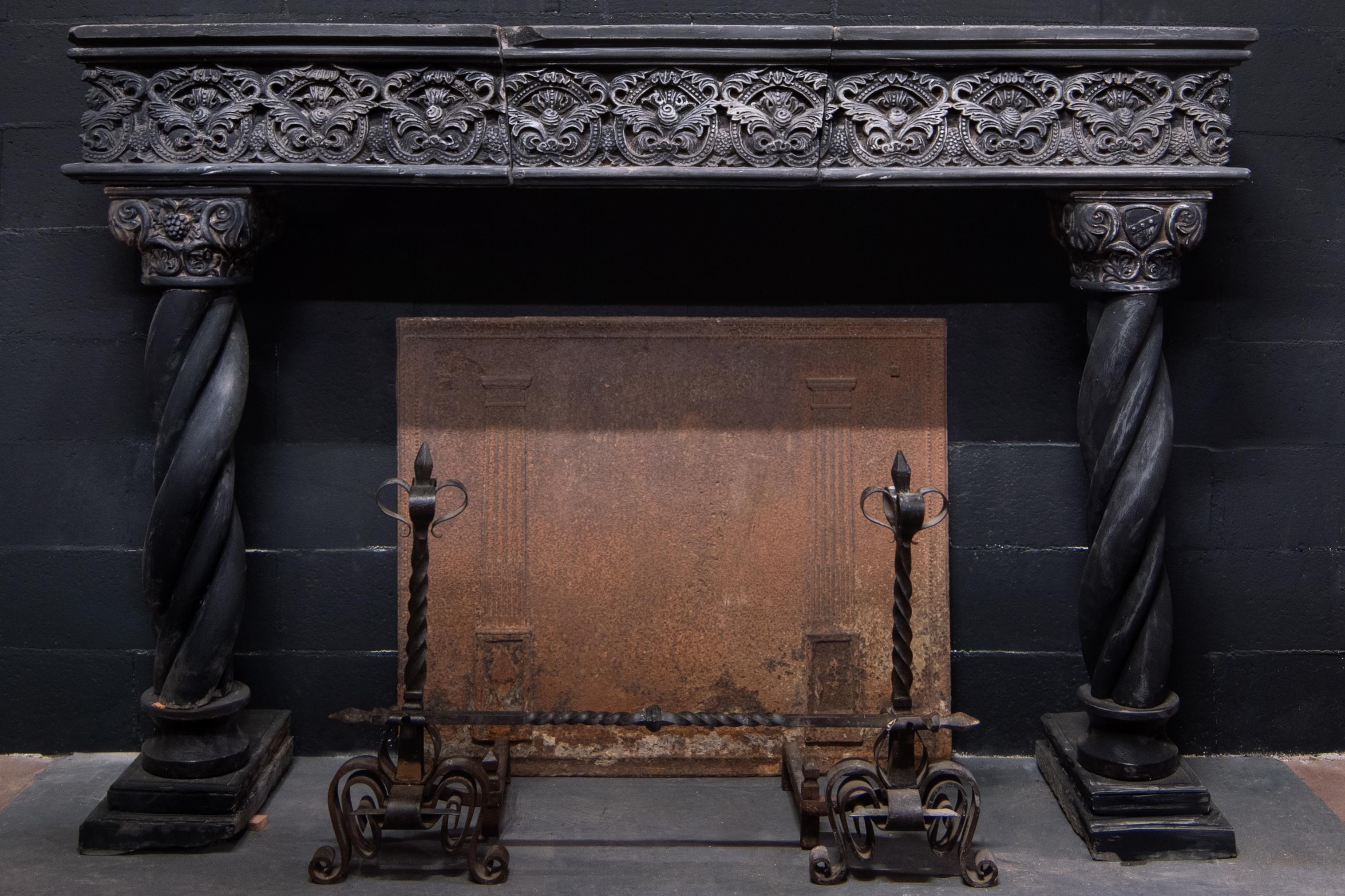 Antique fireplace in dark stone, slate, hand carved with rich frills, cornices and turned columns, hand-built by a 16th century artisan in northern Italy (Genoa), measuring cm: W 190 x H 134.5 x D max cm 47, the internal opening measures cm: W 132 x