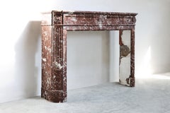 Antique fireplace mantel of Rouge de Belgique marble  Louis XVI style