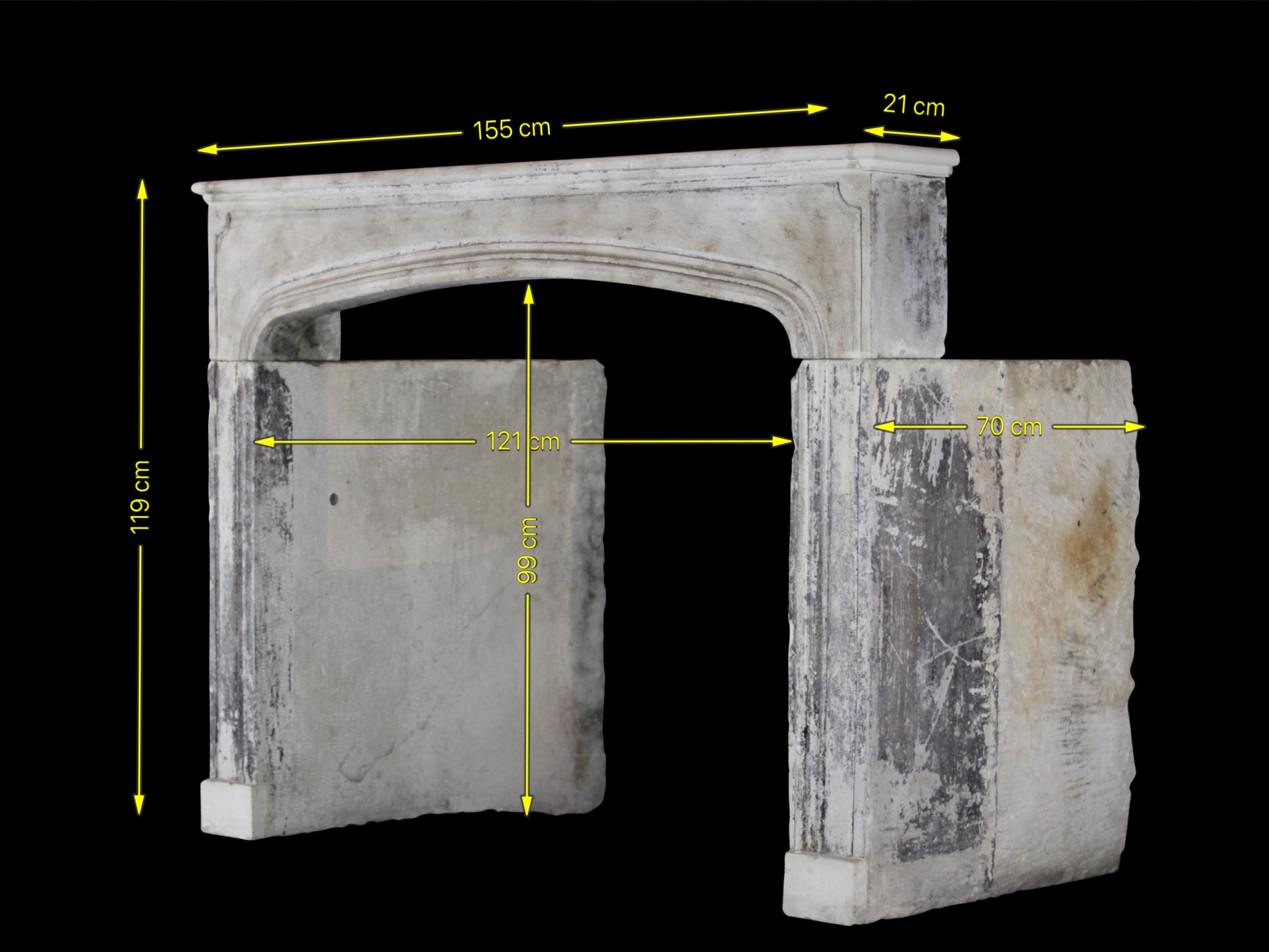 Unusual, one of a kind, French country fireplace surround in limestone. The jambs are deep and round in one block with remains from the original paints and patina. The extremes of the shelf have been restored. It is an original Louis XIV period,