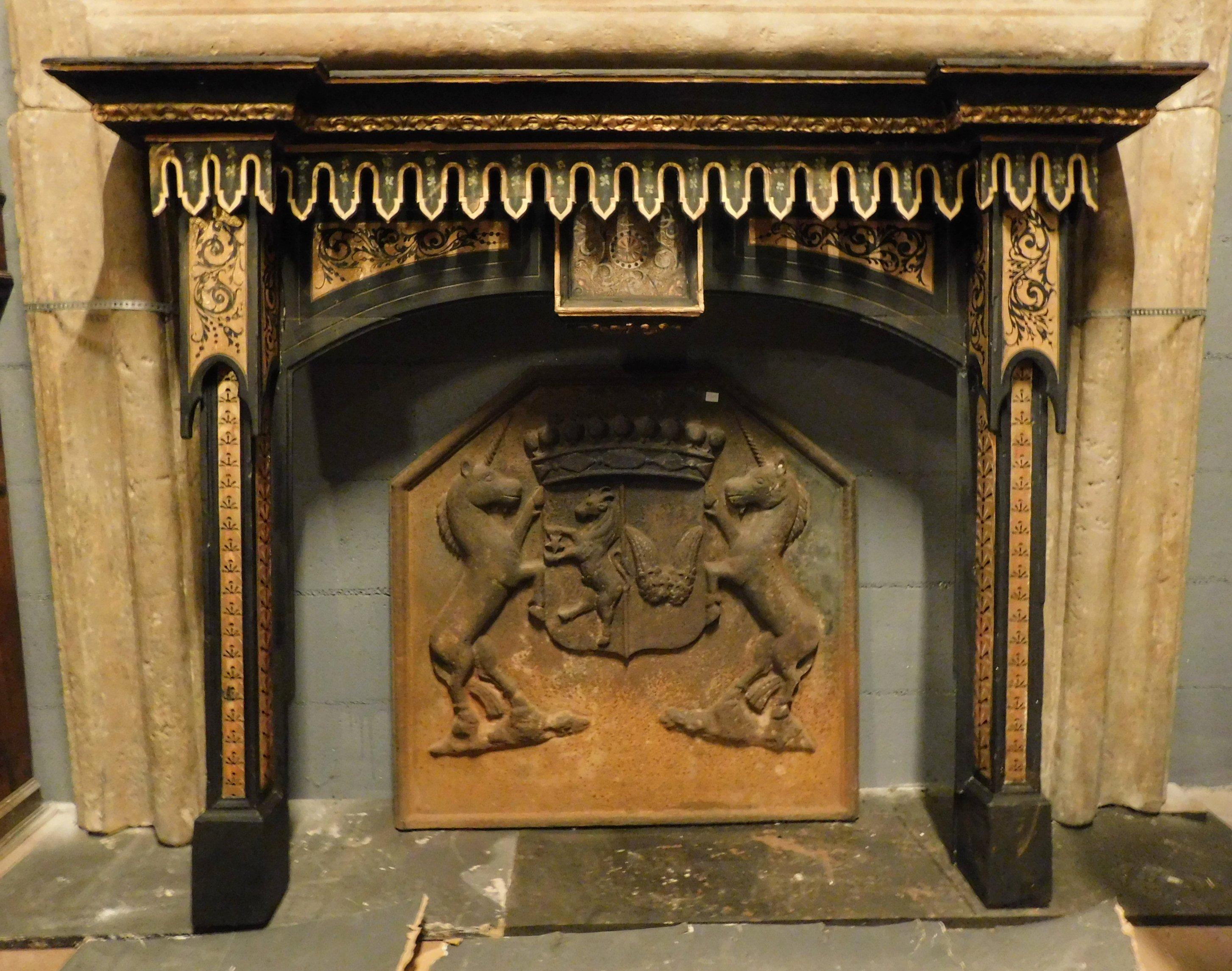 Antique fireplace mantle in black and gold lacquered wood, with spiers and sculptures in full neo-gothic style, therefore from the early mid-19th century, very articulated and of guaranteed artistic effect, very fascinating and valuable, will serve