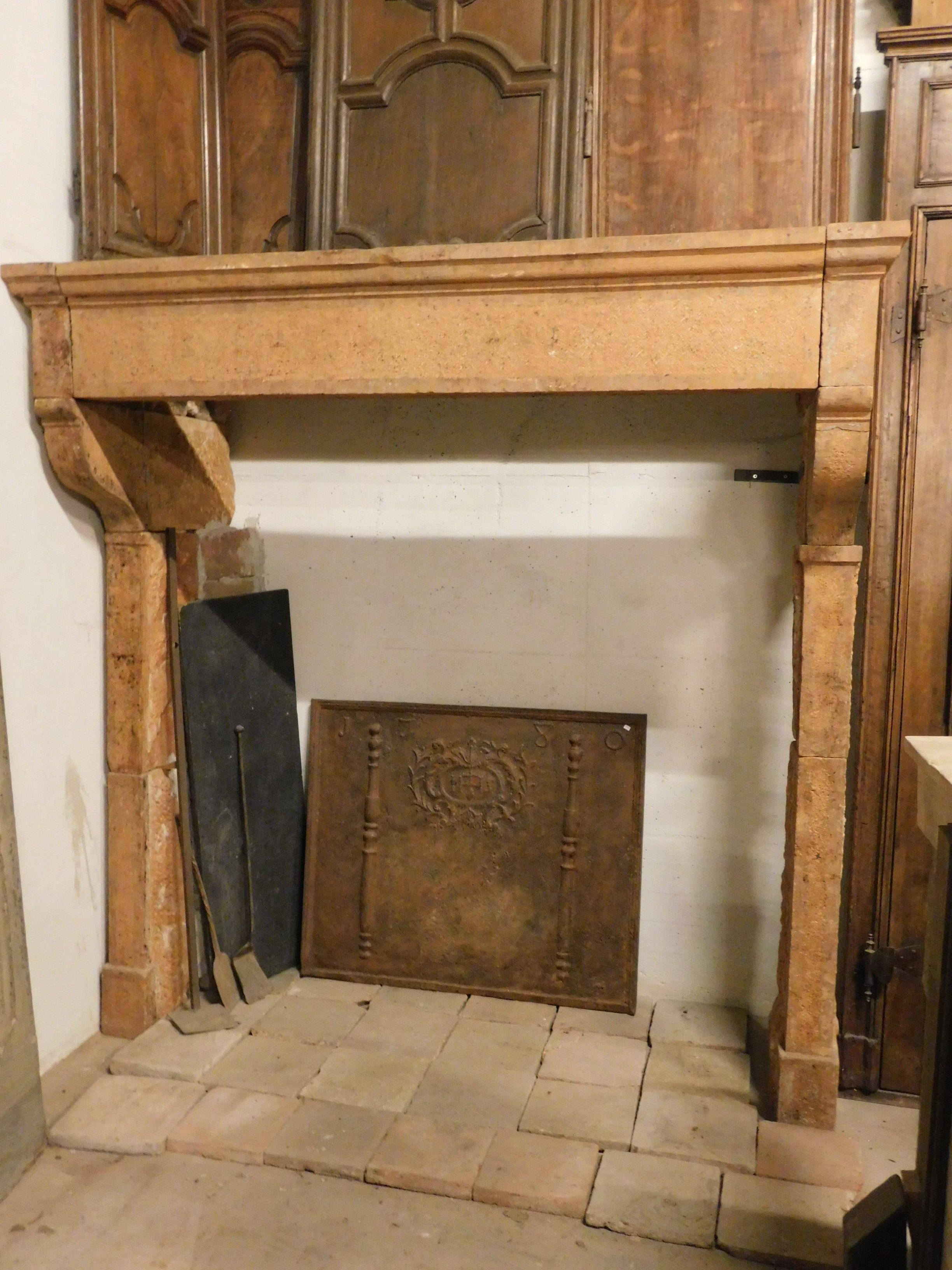 Ancient and important mantel fireplace, hand-carved in burgundy stone, with typical orange color of the stone, it was built for large room / kitchen for historic building of the 18th century, origin France, ideal for setting up modern kitchens or