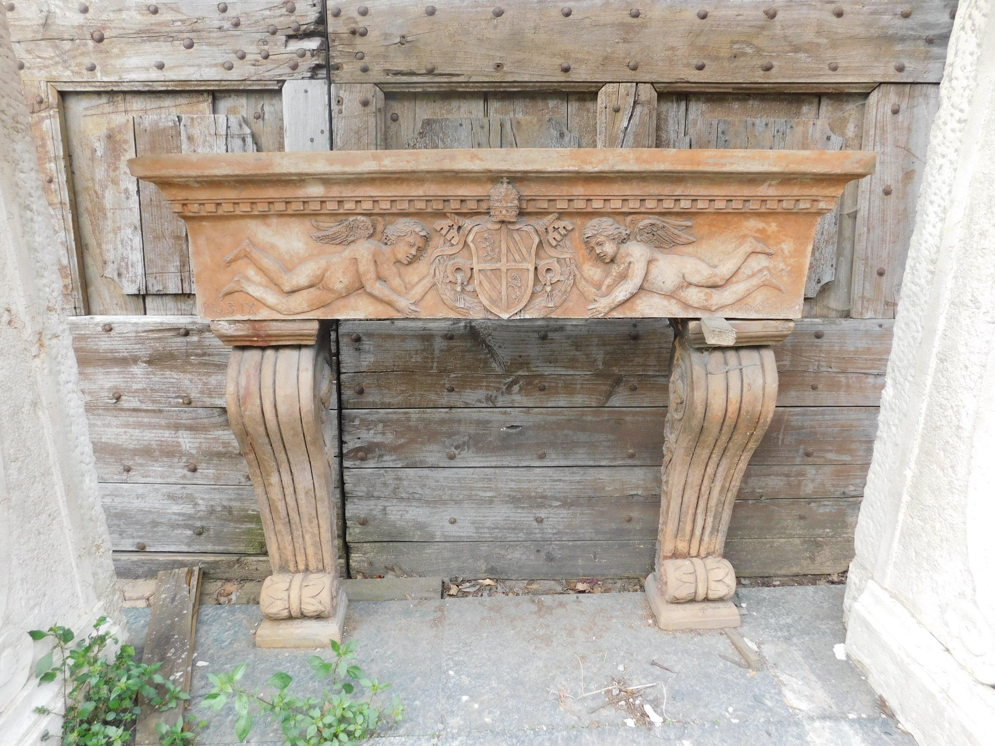 Italian Antique Fireplace Mantle in Terracotta Carved with Cherubs, 20th Century Italy For Sale