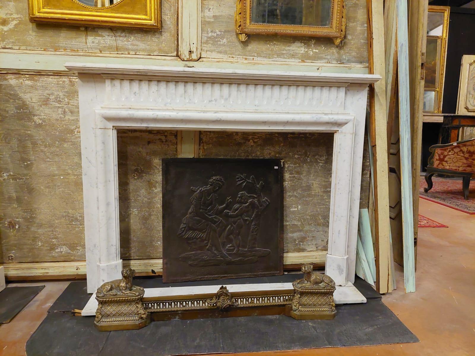 Antique fireplace mantle in white Carrara marble, first half of the 19th century, from France, elegantly sculpted by hand, has a geometric shape that adapts well to both classic and more modern interiors, simple and elegant even if refined, it will