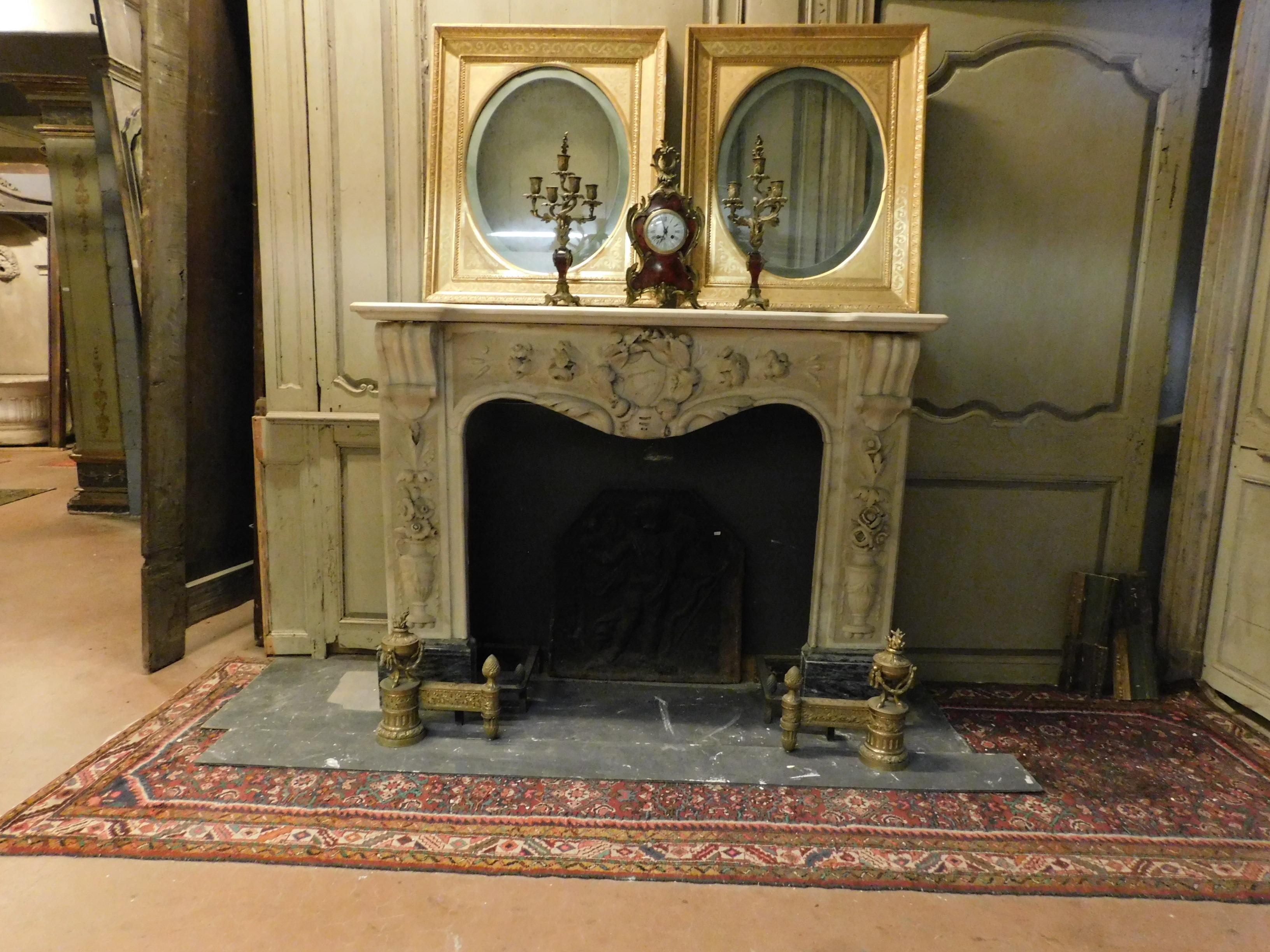 Antique white carrara marble fireplace, richly carved on all sides with contrasting gray marble feet, very rich and precious, rare to find in these conditions and so particular, mantel fireplace built entirely by hand in the second half of the