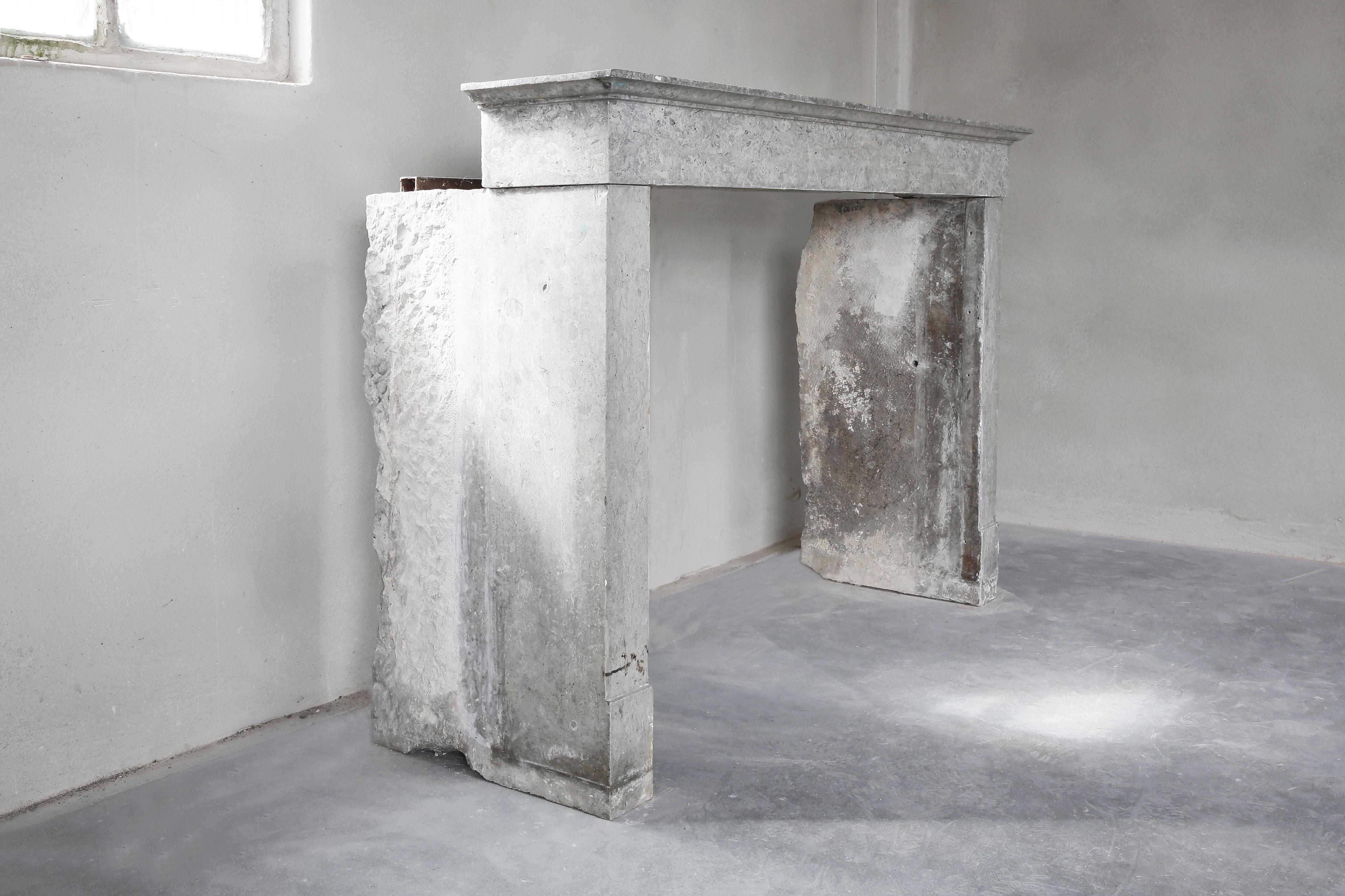 A beautiful antique fireplace of a special marble. This fireplace comes into its own especially from close up. The marble stone contains several smaller stones and gives an authentic look to the fireplace. It dates back to the 19th century, is tight