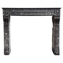 Antique fireplace of black marble with white veins from the 19th century