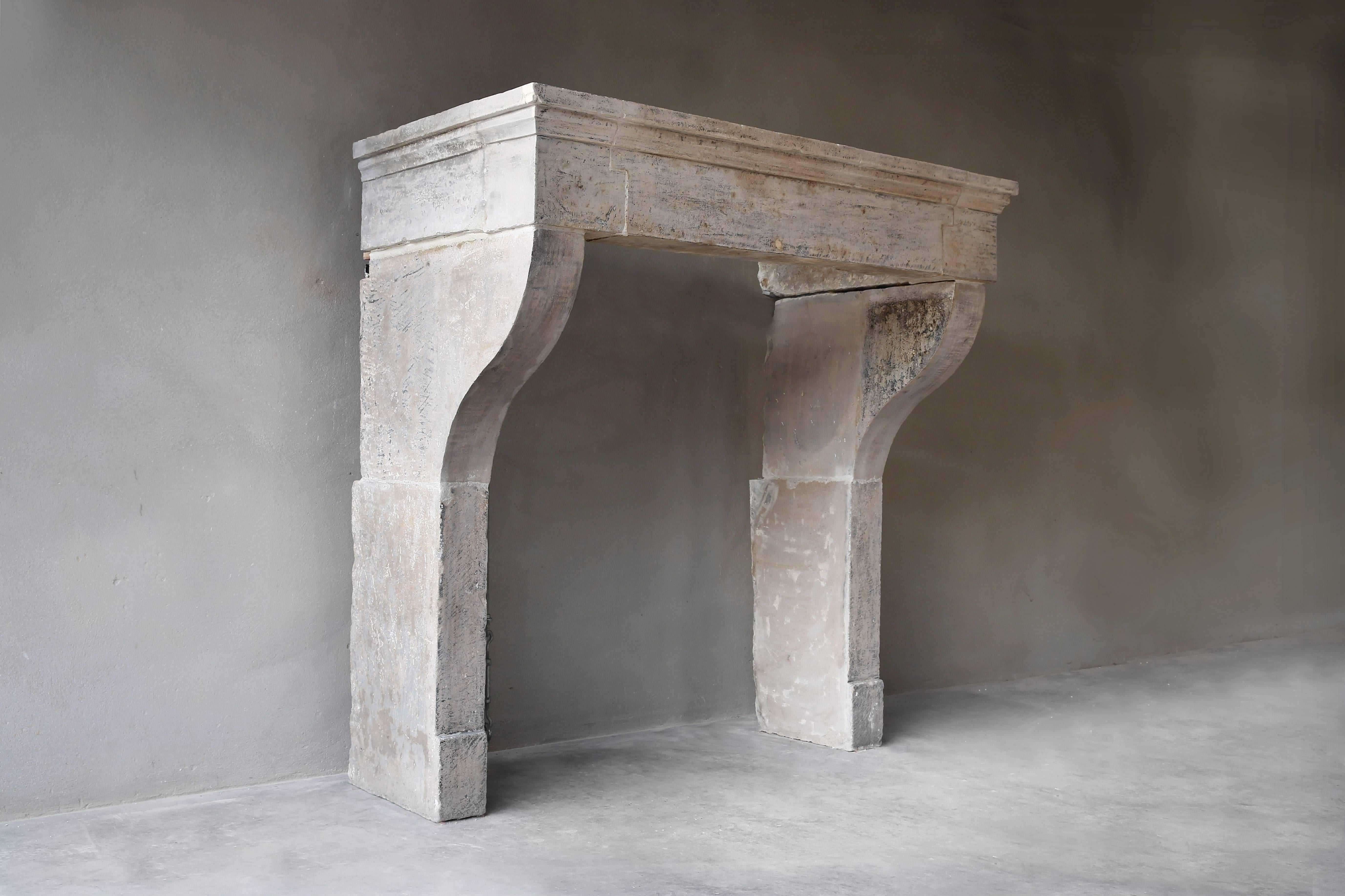 A very nice and sober antique fireplace of French limestone in the Campagnarde Style. This fireplace has the right proportions, a good moulure and nice front part. Also the color tones of this one are very nice!