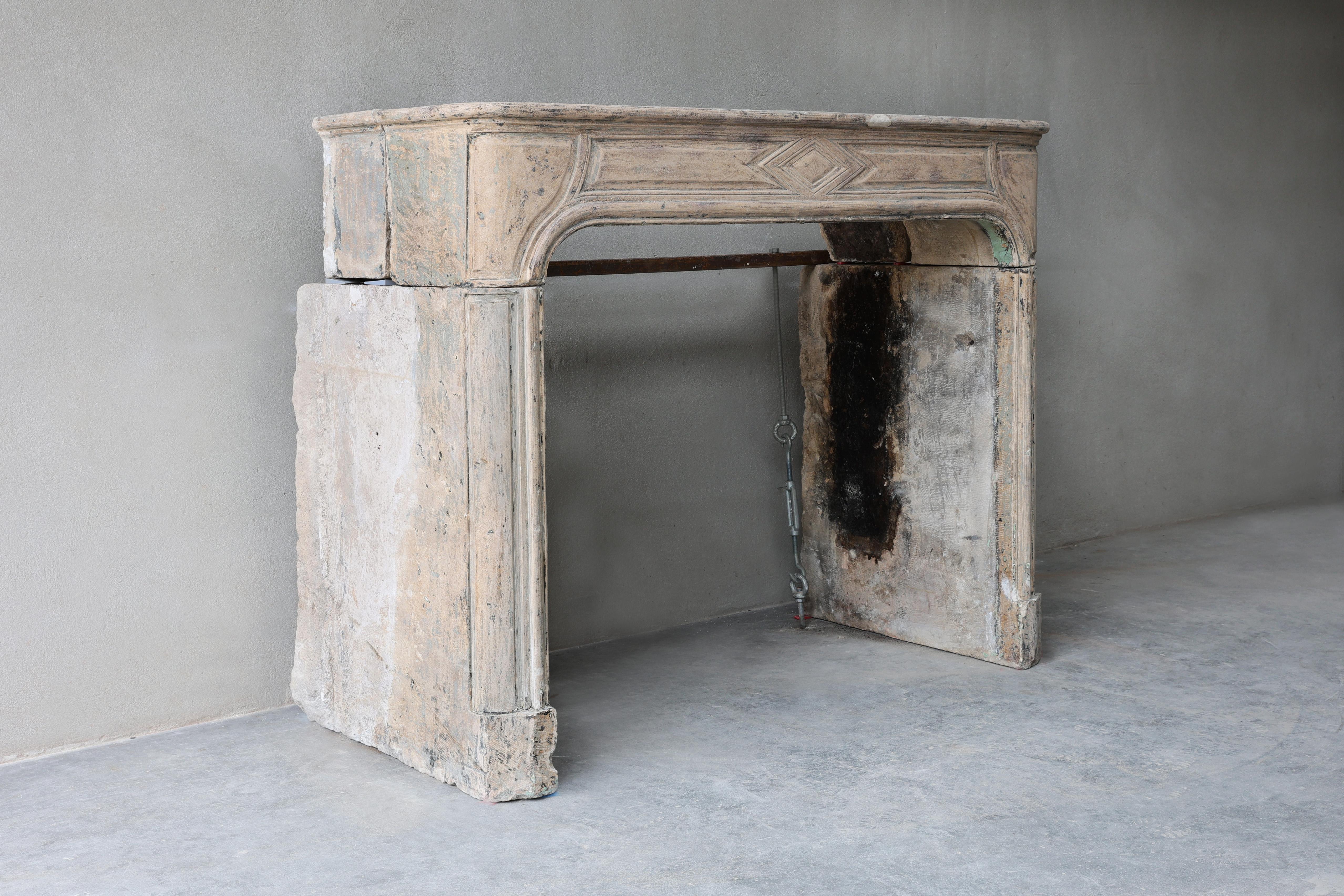Beautiful compact antique fireplace made of French limestone. A 19th century fireplace in Louis XIV style! Equipped with beautiful lines and patina.