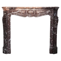 Antique fireplace of Griotte Rouge marble form the 19th century