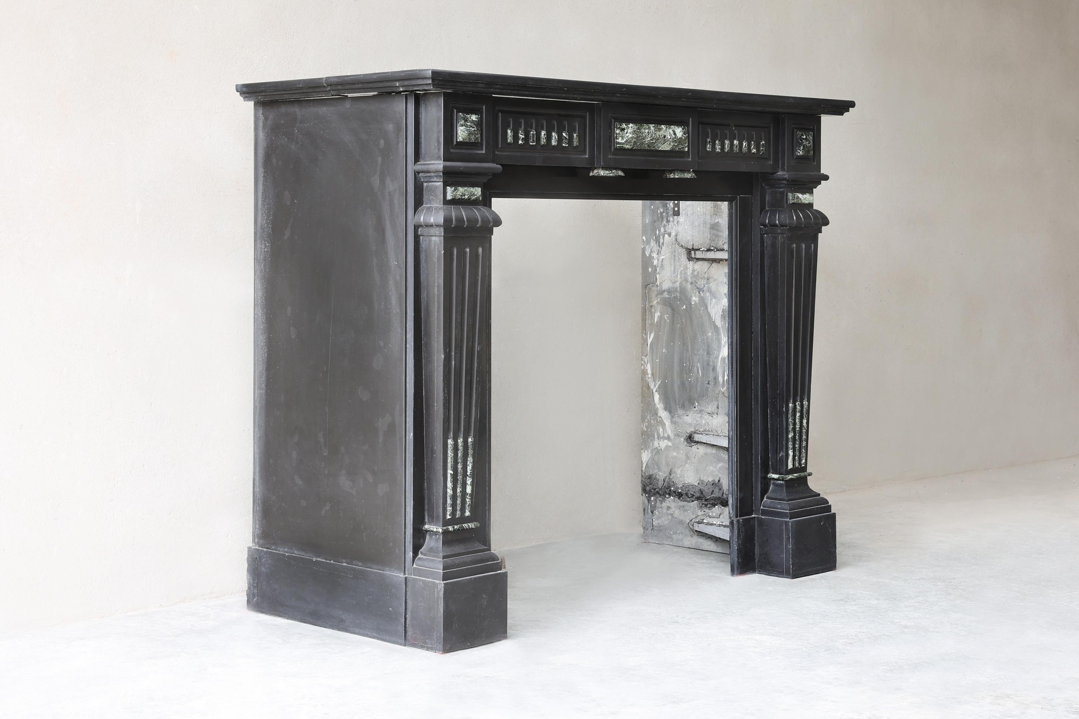 This timeless elegant 19th century fireplace is made of the rare marble Noir de Mazy marble, the deep black Belgian marble known for its luxurious appearance. Executed in the refined Louis XVI style, this fireplace exudes pure class and