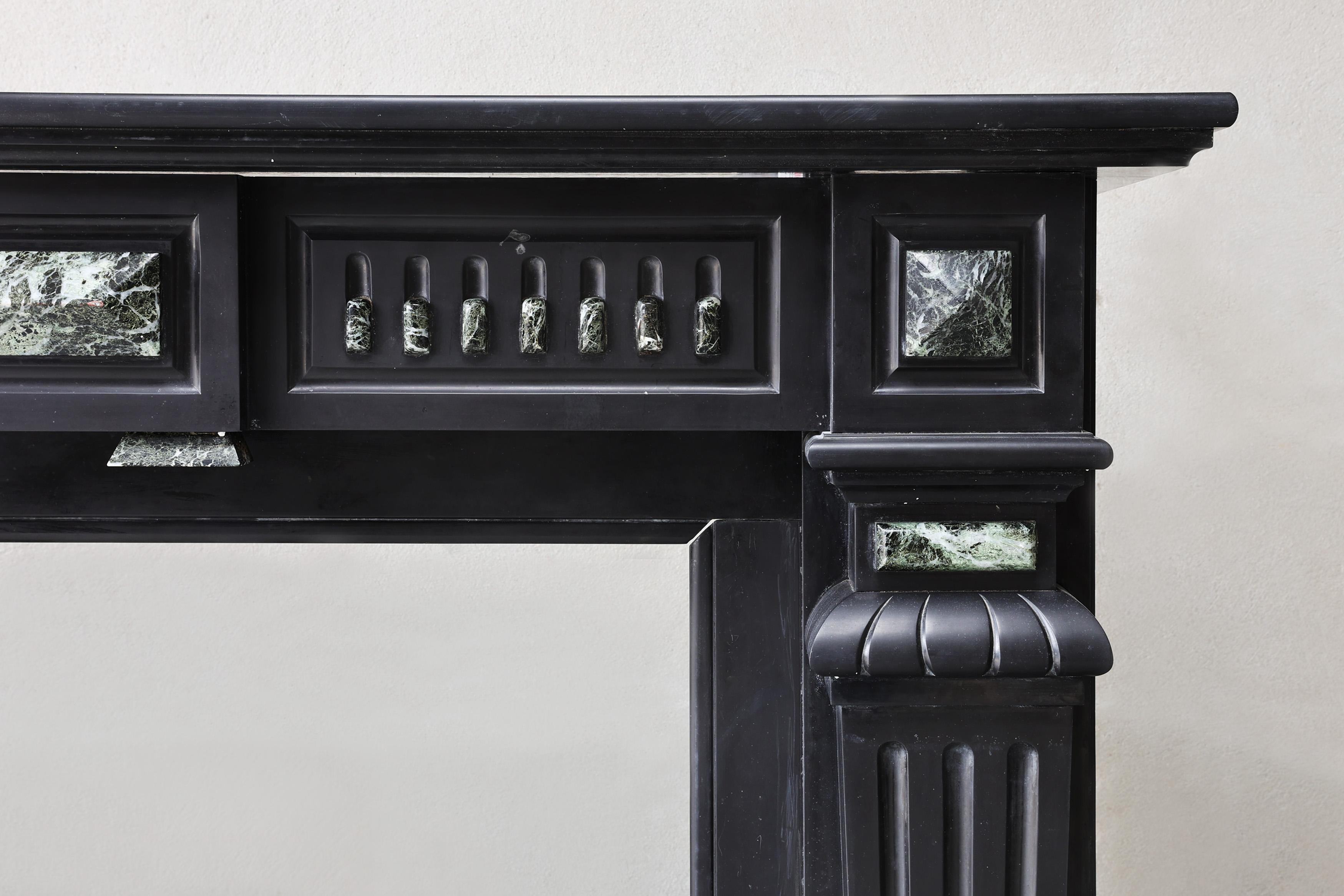 French Antique fireplace of Noir de Mazy marble, 19th century, Louis XVI style For Sale