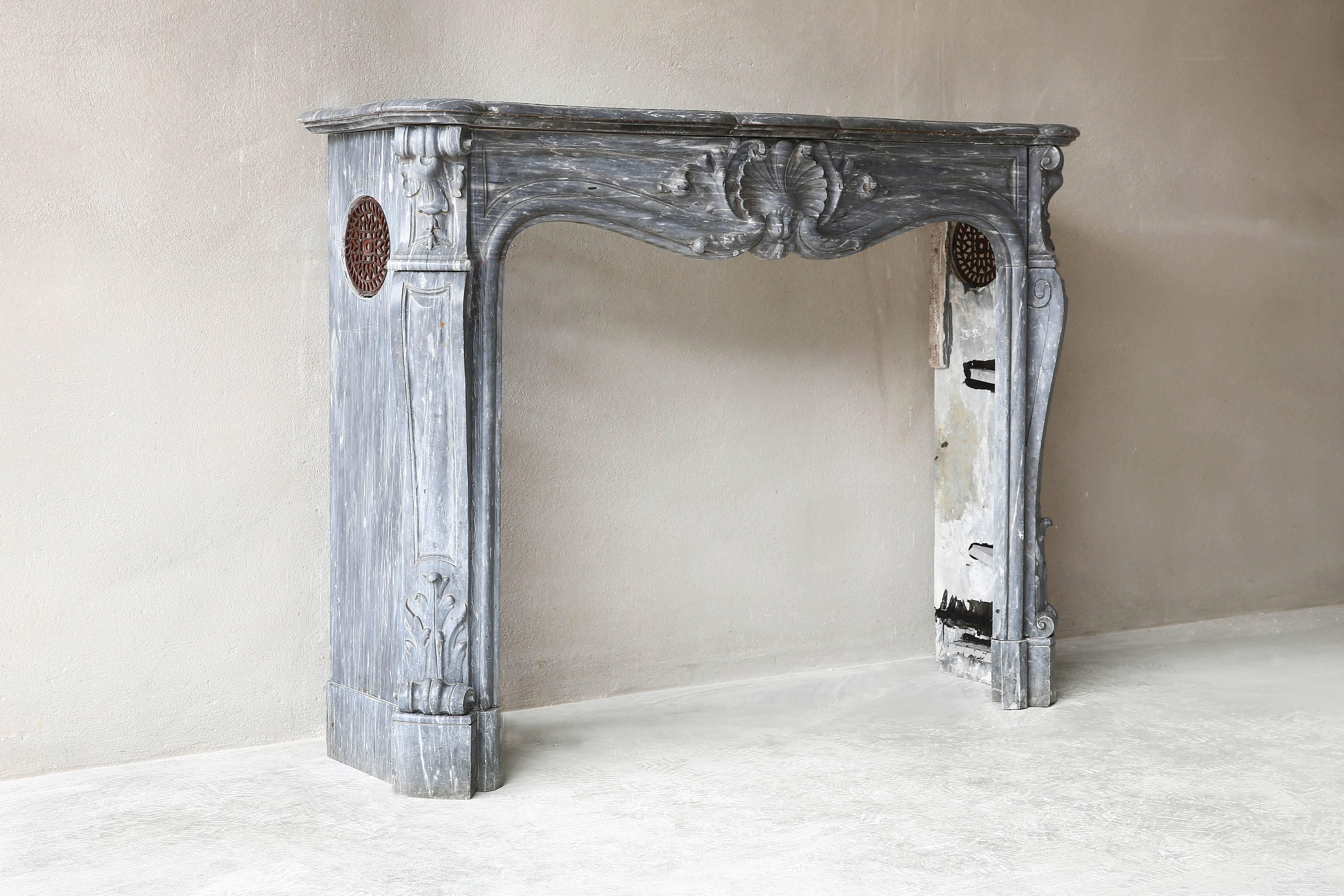 This very unique antique marble fireplace is made from the Italian marble type blue turquin. This Italian type of marble is extracted from the quarries of the Apuan Alps, such as Carrara, where it is called Bardiglio Carrara. It can also be found in