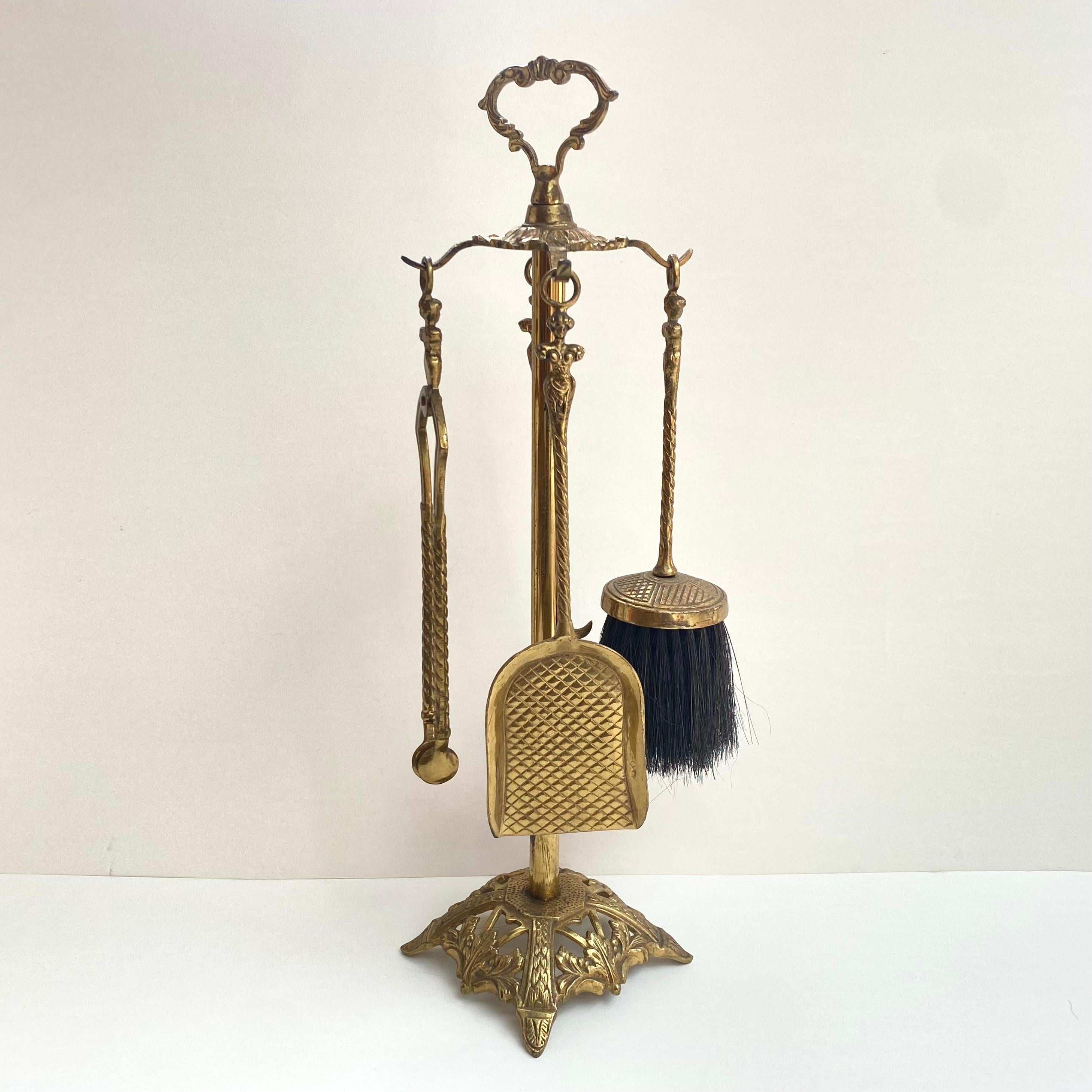 Unique forged bronze and brass antique stand with fireplace accessories in Baroque Style of early 20th century.

Classic design with little embellishment, shiny, made of cast bronze and brass. Interesting design handles.

The fireplace set