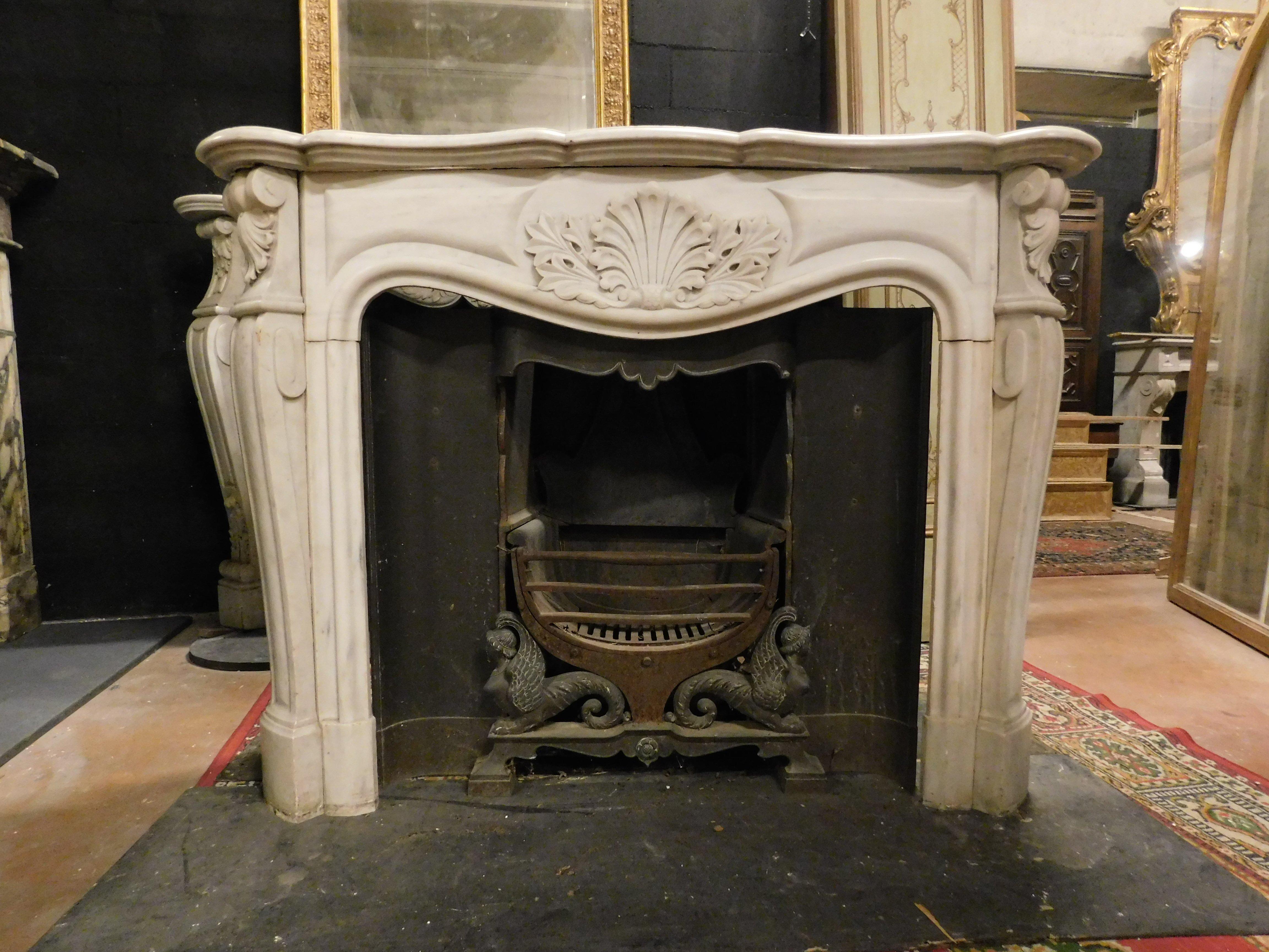 Ancient fireplace mantle in white Carrara marble, richly carved with leaves on the sides and central shell, built in the 18th century for an important noble palace in France.
Not including interior (please ask if available, with additional price),