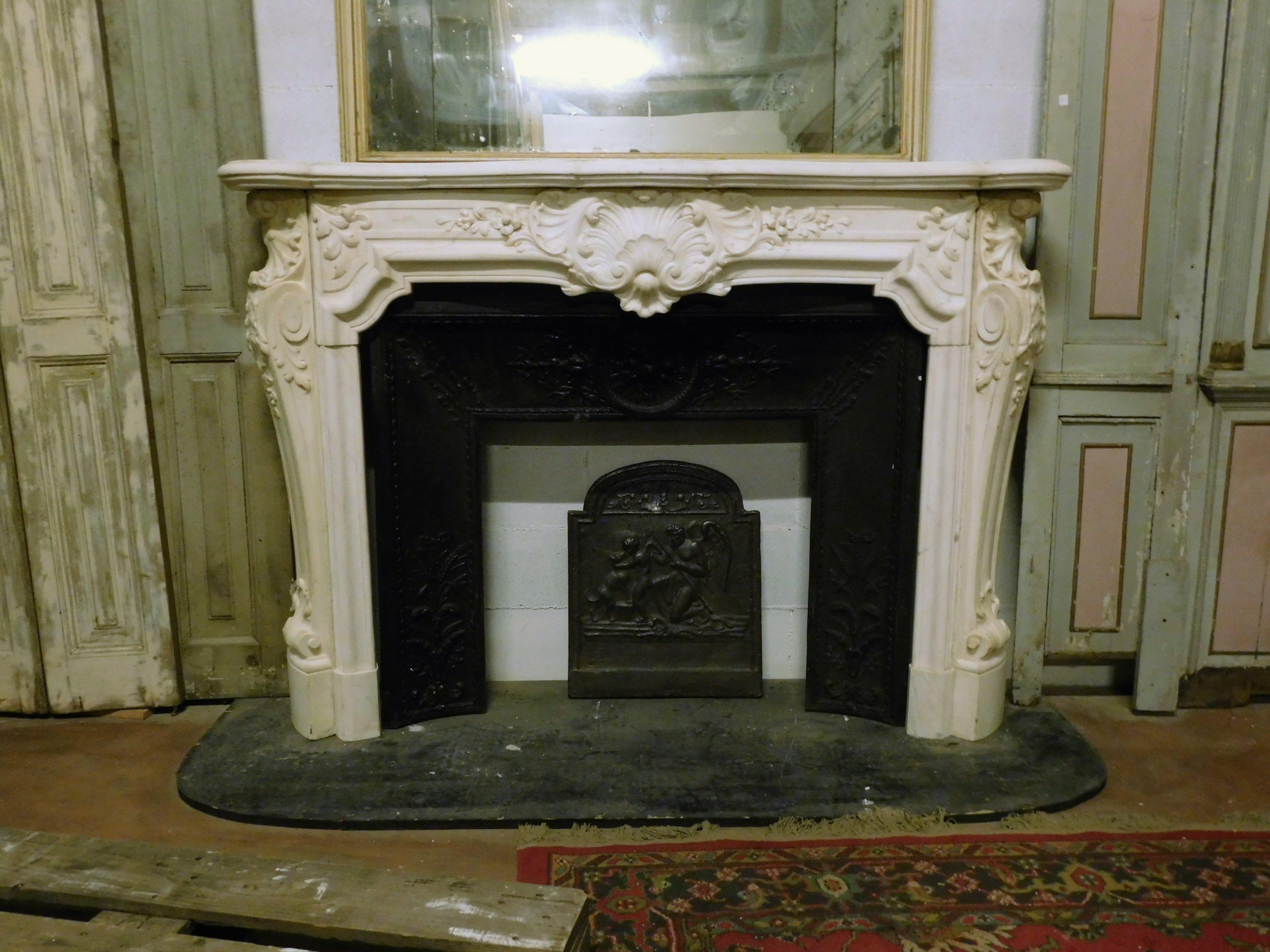Ancient and important fireplace in white statuary marble of Carrara, richly carved by hand with festoons and flora typical of the decorations of the time, with many sculptures both on ga, be and on the pediment, carved entirely by hand in the early