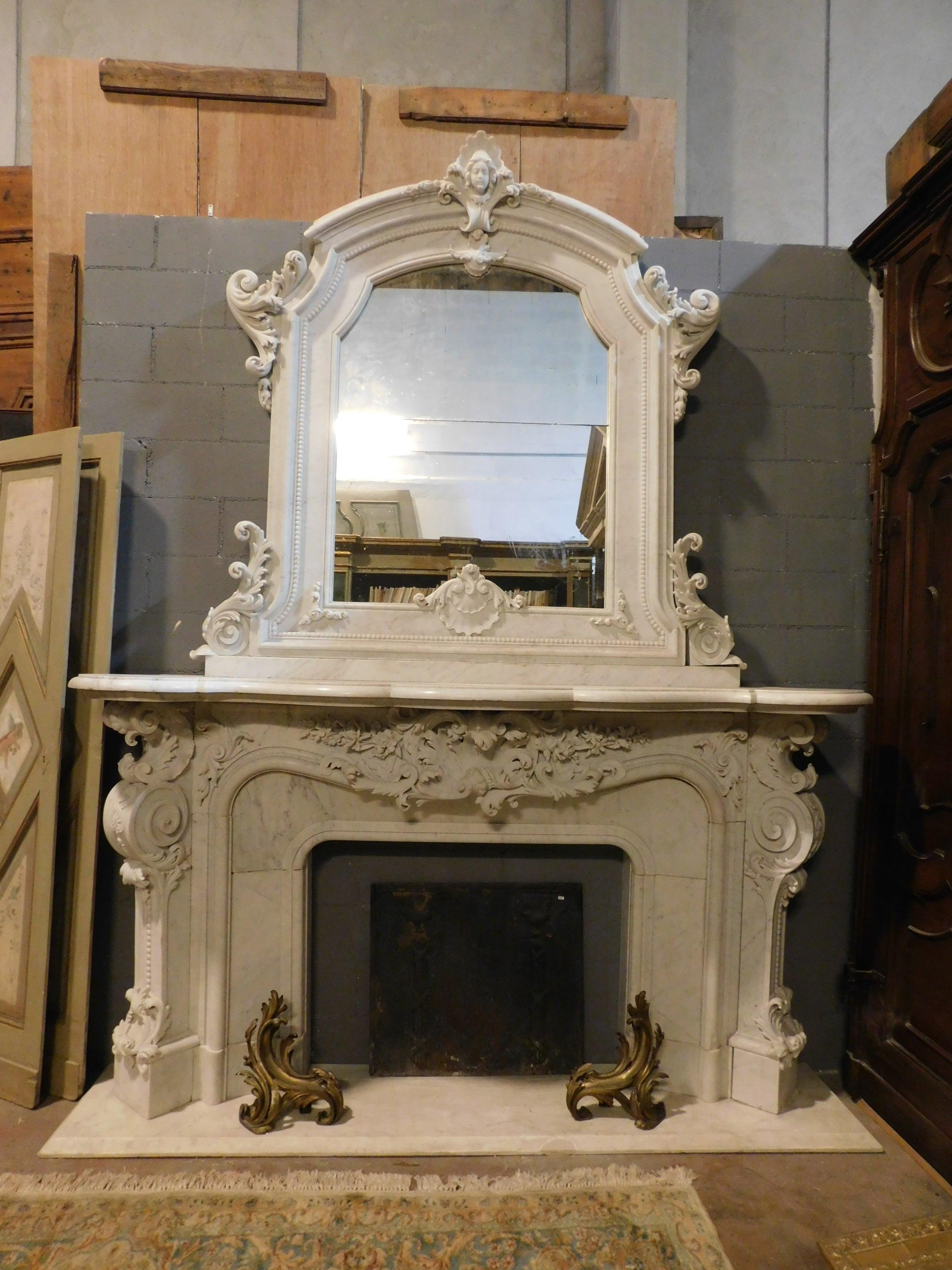 Ancient fireplace mantle in typical statuary white marble richer than Carrara marble, very rich in hand-made sculpture, with many doodles, swirls, moves and decorations, complete in everything: mirror, fireplace, base. Hand-sculpted both on the