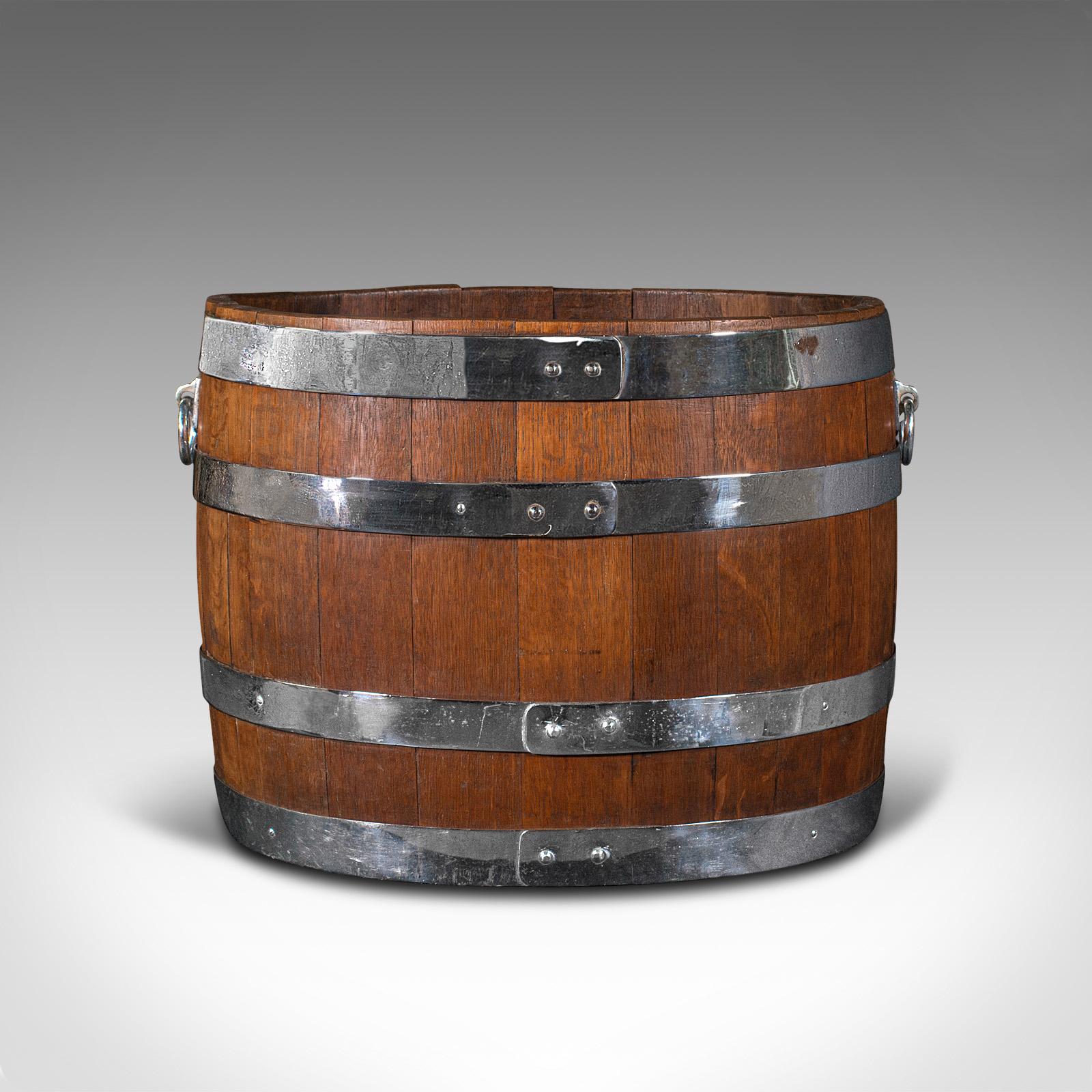 This is an antique fireside bin. An English, oak and chrome coopered half barrel log or coal cask, dating to the Victorian period, circa 1850.

Of appealing, unusual oval form and character
Displays a desirable aged patina throughout
Select oak