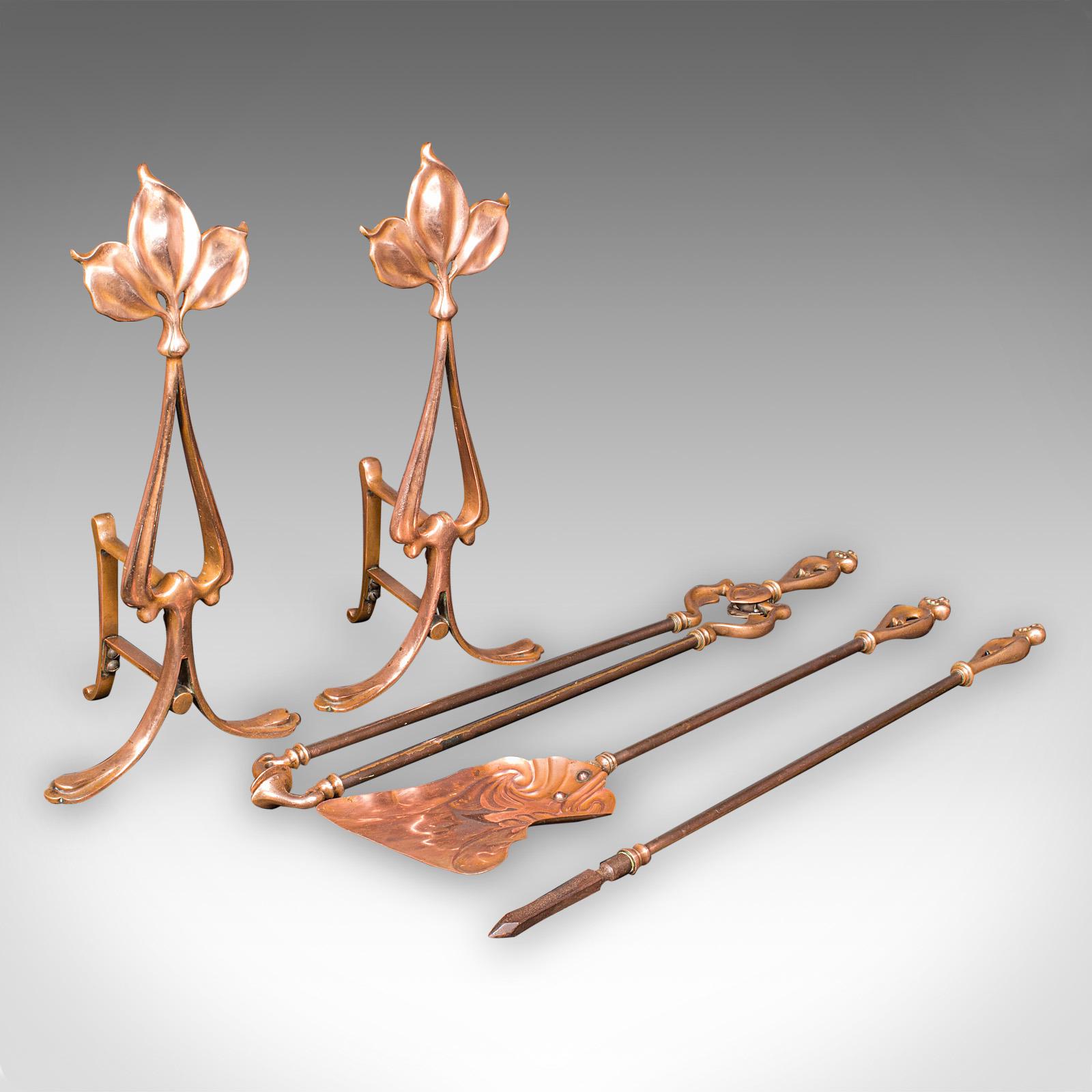 This is a superb antique fireside companion set, comprising a pair of French bronze andirons and a trio of fire tools in Art Nouveau taste, dating to the late Victorian period, circa 1890. Rich in decorative allure and functionality, this