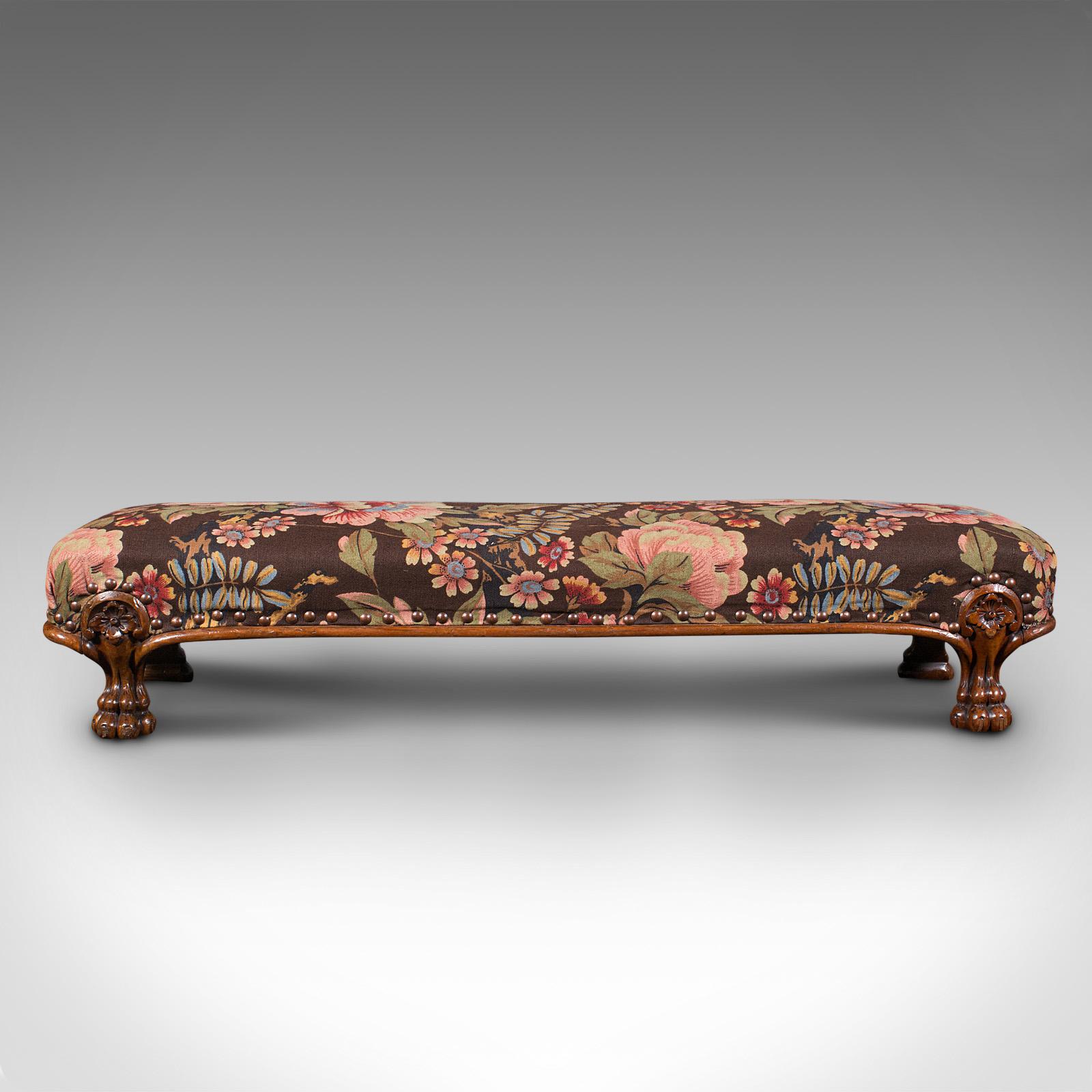 This is an antique fireside foot rest. An English, walnut kneeling or gout stool, dating to the mid Victorian period, circa 1860.

Vivacious upholstery and of a generous size
Displays a desirable aged patina throughout
Select walnut stocks show