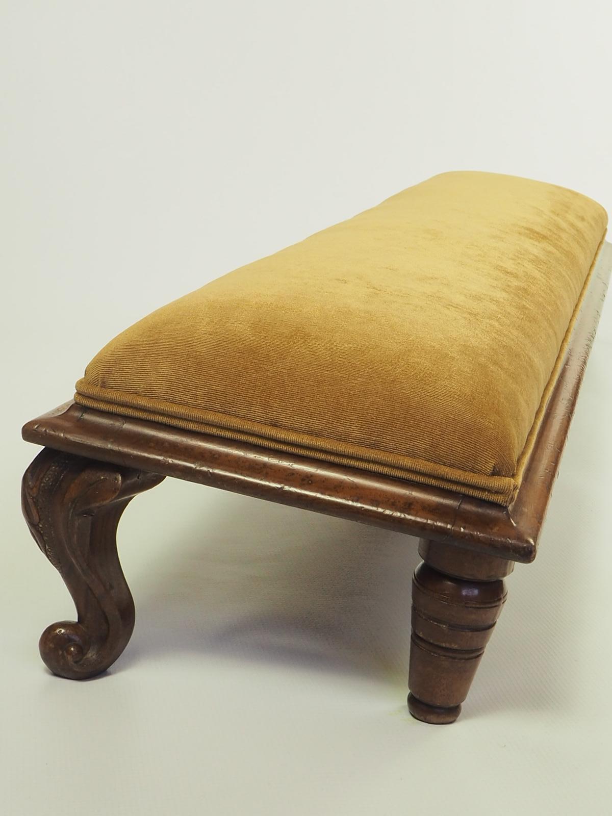 This is an antique fireside foot rest. An English, Walnut kneeling stool, dating to the early Victorian period, circa 1860

A very beautiful solid walnut frame over a meter wide in a graduated position, raised on cabriole legs – perfect for