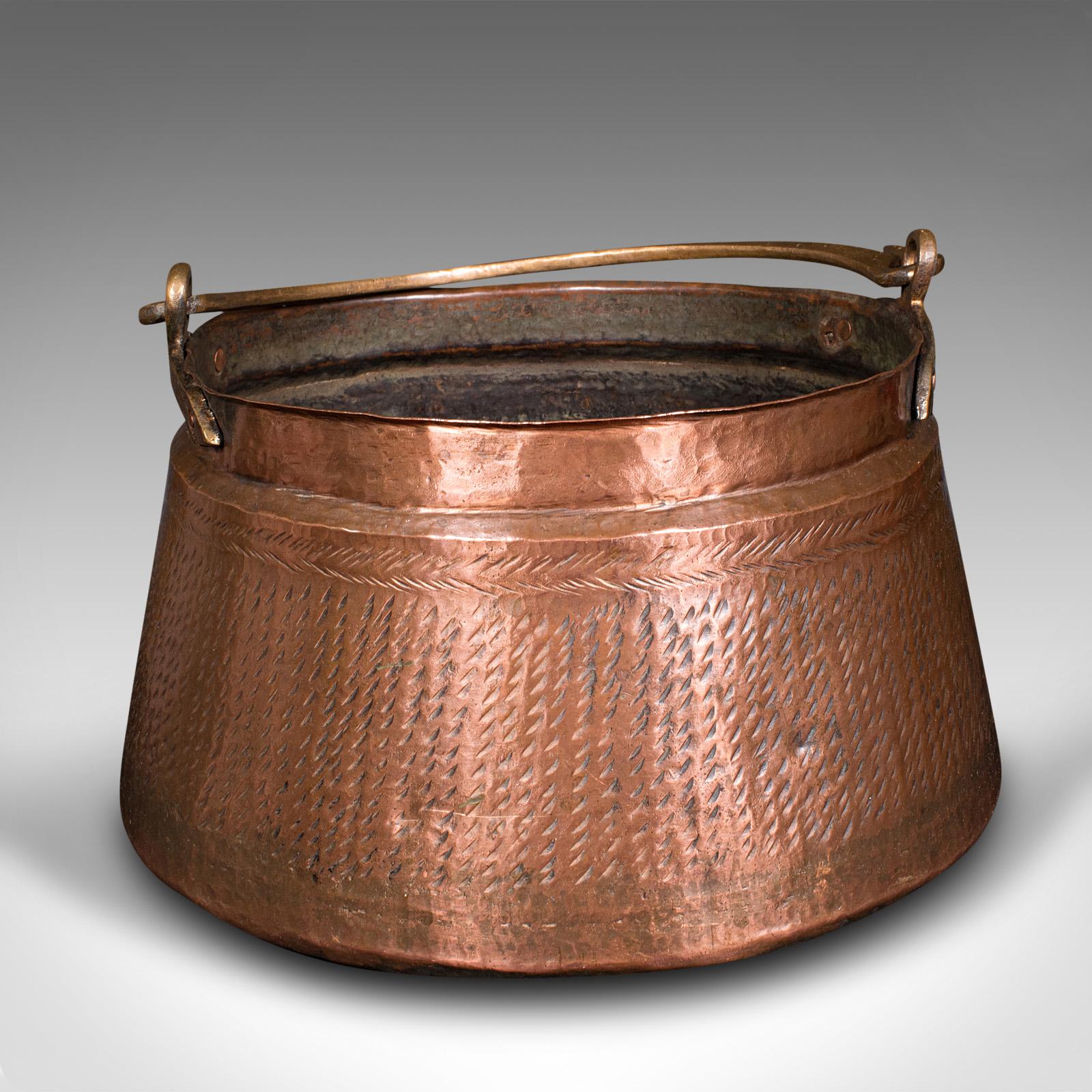 This is an antique fireside fuel basket. An Indian, copper and bronze handled daal pot, dating to the early Victorian period, circa 1850.

Appealingly original pan, ideal for fireside storage
Displays a desirable aged patina and in good original