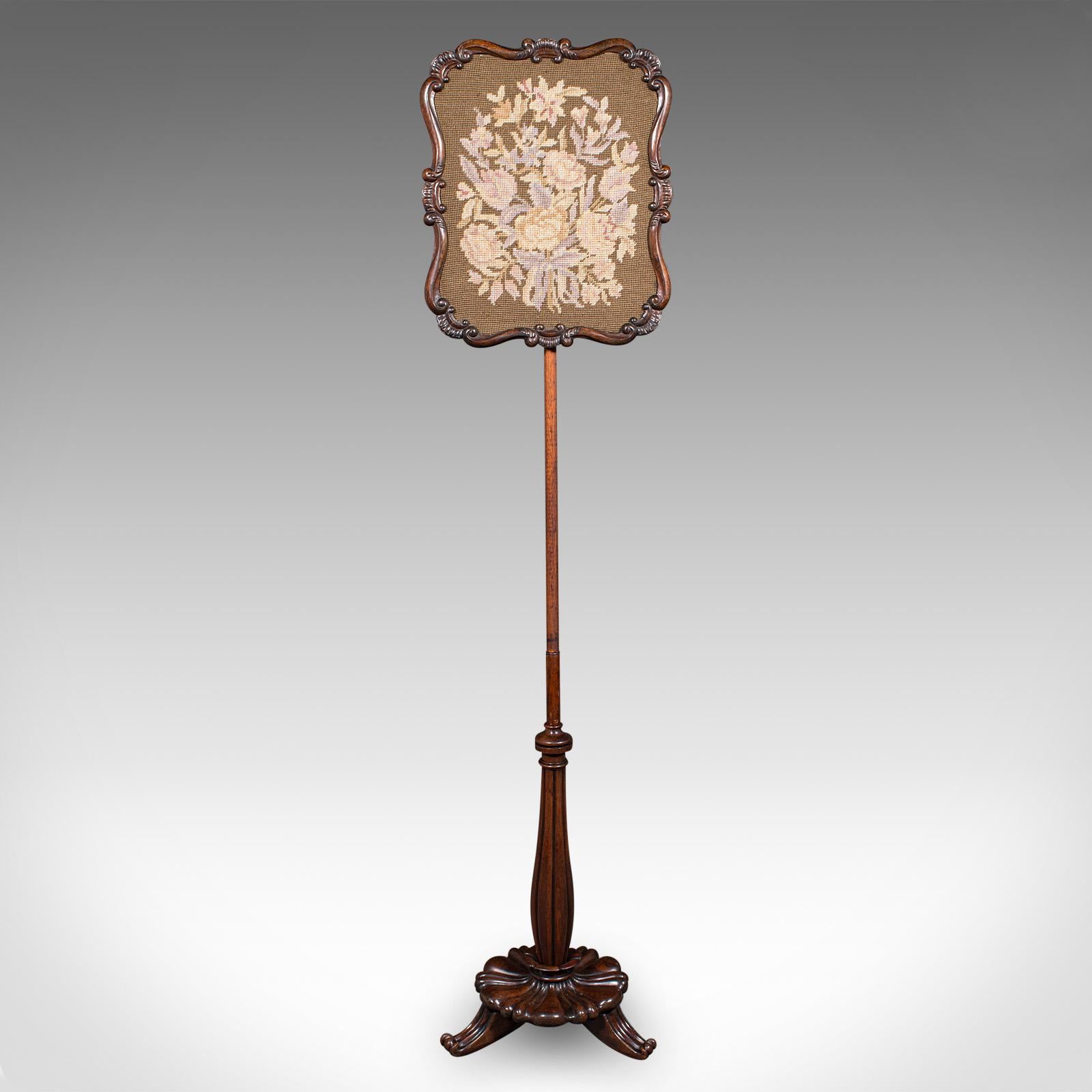 This is an antique fireside pole screen. An English, rosewood and needlepoint tapestry adjustable shield, dating to the William IV period, circa 1835.

Excellent William IV craftsmanship, offering ideal decoration for the fireside
Displaying a