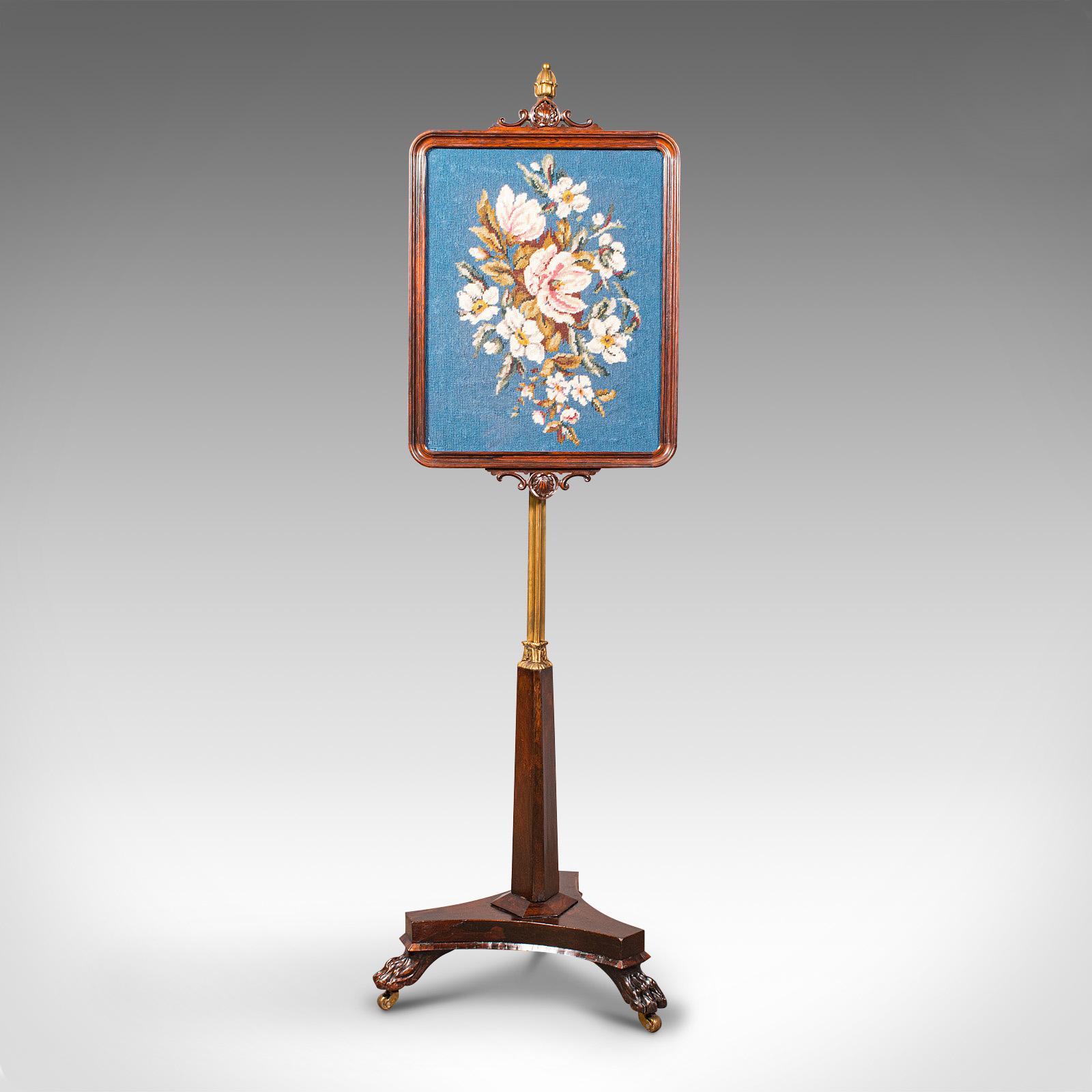 This is an antique fireside pole screen. An English, Rosewood and ormolu adjustable fire screen with needlepoint panel, dating to the William IV period, circa 1830.

Attractive adjustable fireside pole screen
Displays a desirable aged patina and