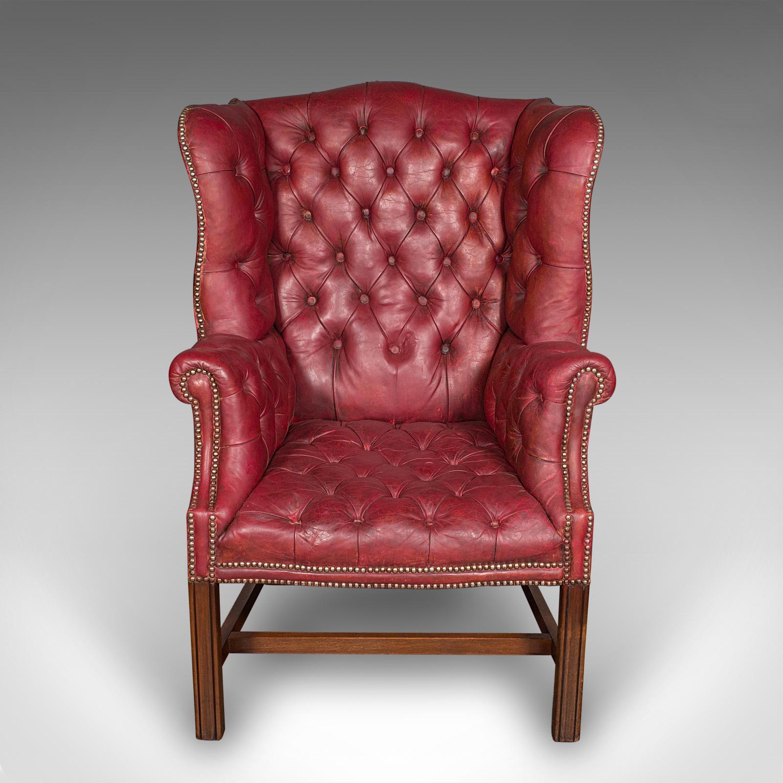 
This is an antique fireside wing back armchair. An English, leather buttoned lounge chair dating to the Edwardian period, circa 1910.

Traditional appeal to this charming fireside chair, with deep proportion
Displays a desirable, lightly time worn