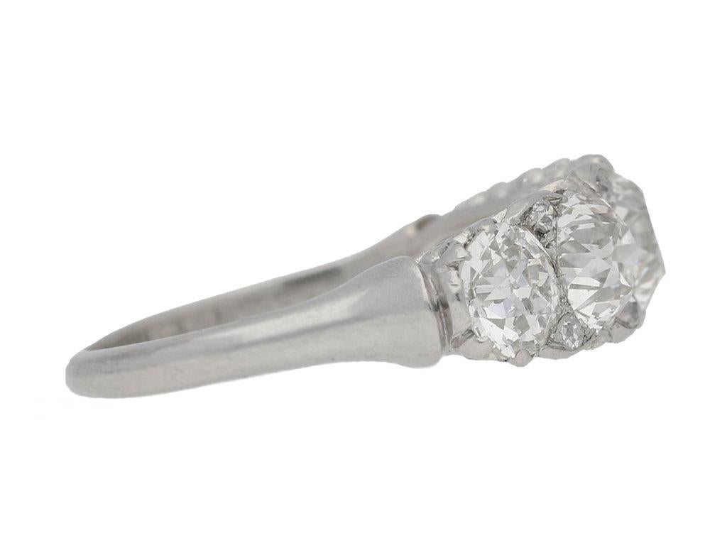 Antique five stone diamond carved half hoop ring. Horizontally set with five round old cut diamonds in open back claw settings with a combined weight of 4.80 carats, further set with diamond points of eight round old single cut diamonds in grain and