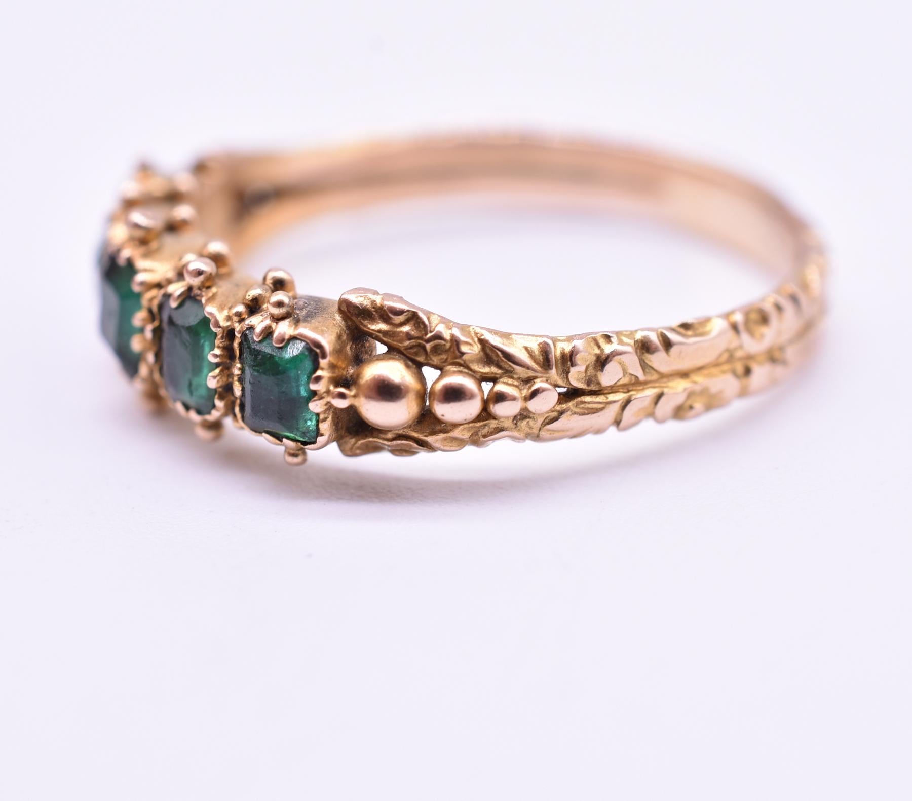 Lovely 18K late Georgian 5 stone closed-back emerald ring. Repousse work on the band and delicate gold balls above and below the emeralds are especially pleasing to the eye. Georgian closed-back rings like this one were backed with foil to enhance