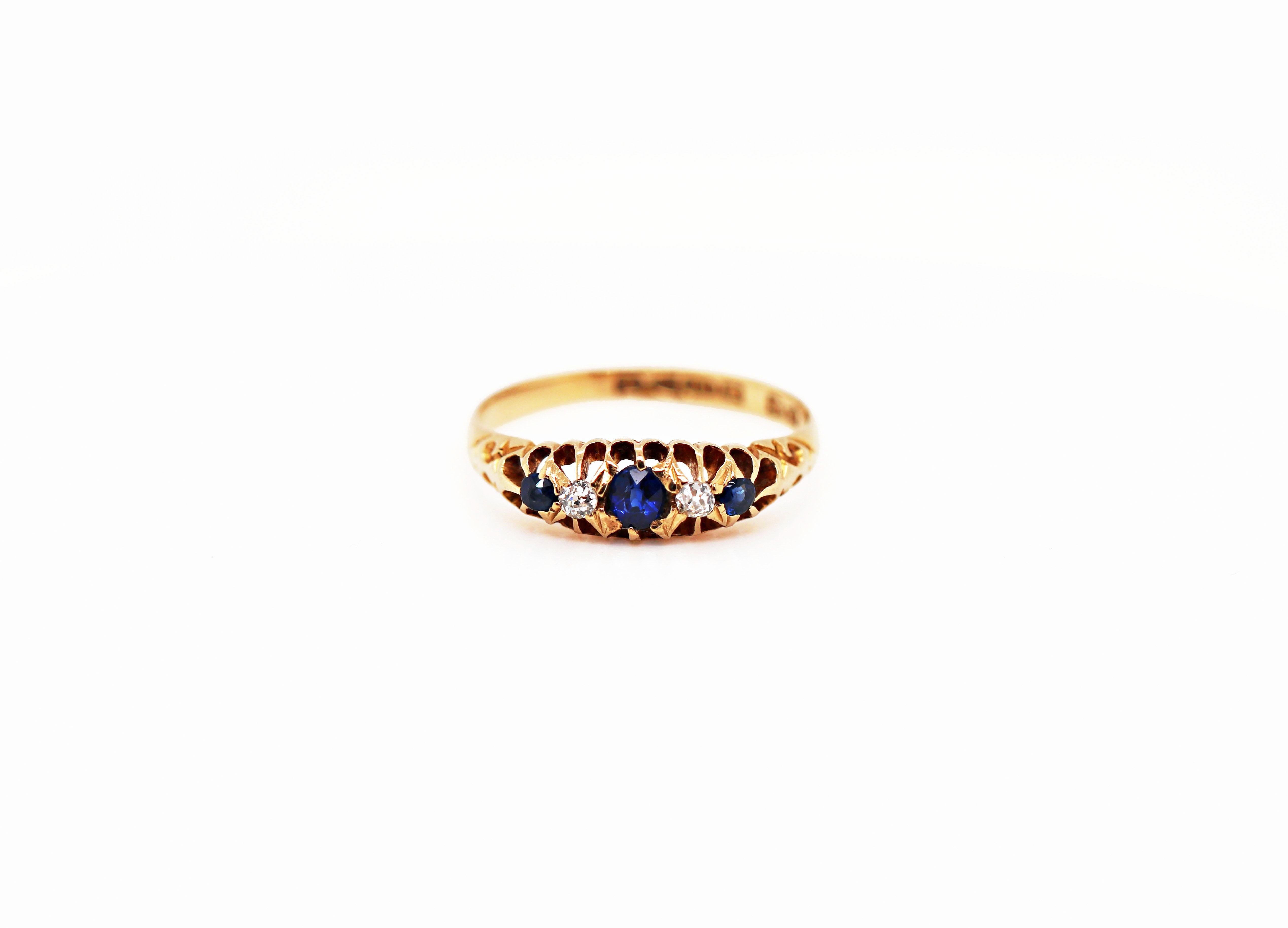 This antique ring features 3 royal blue sapphires accompanied by two old cut diamonds all mounted in a classic original Edwardian 18 carat yellow gold setting. English Hallmarks - 1906. UK finger size 'M'. 