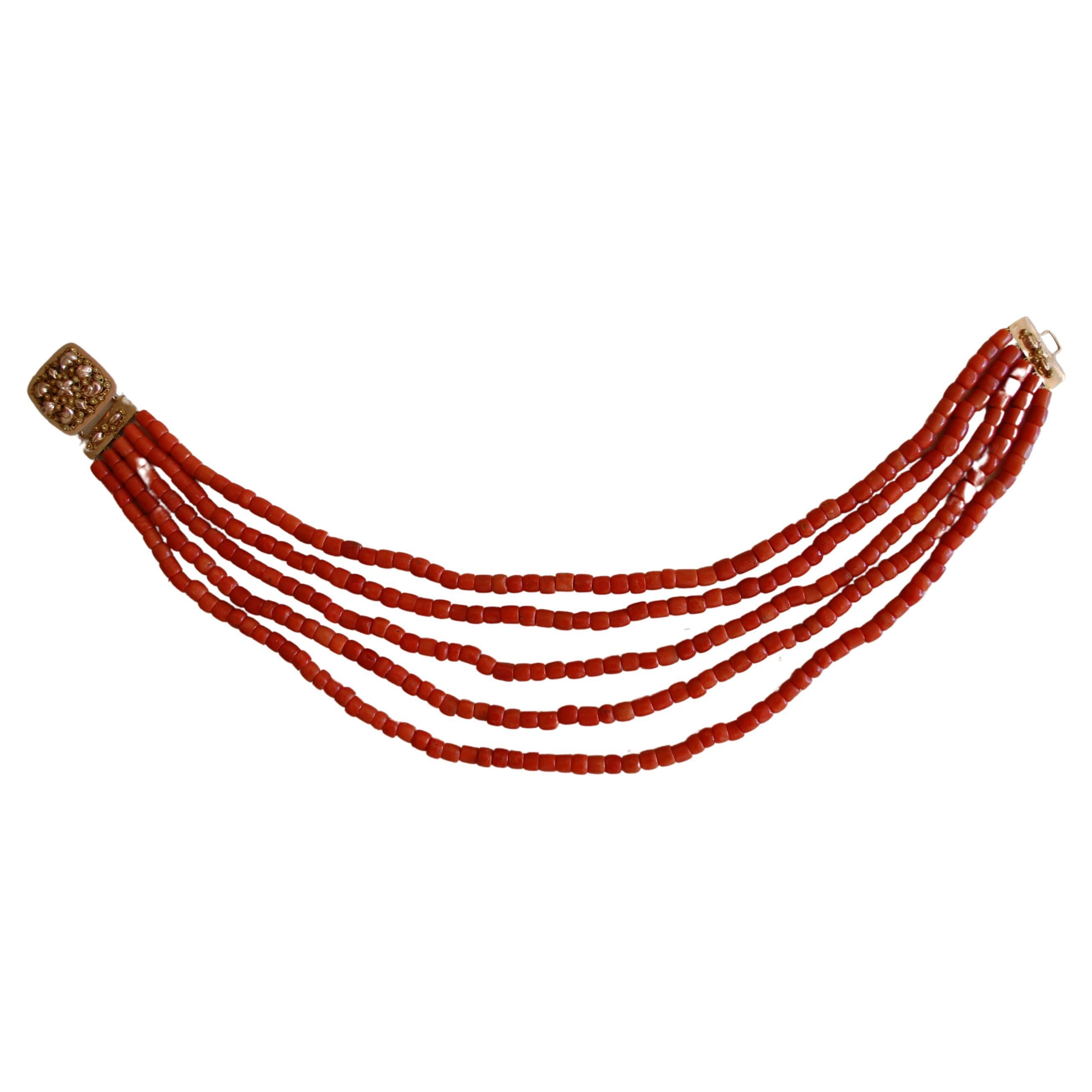 Stunning antique Coral choker necklace.
A five strand of fine European natural red/salmon coral  necklace beads about 5-6mm dimension. The coral beads are barrel-shaped and the handmade clasp is made of 14k yellow gold. The clasp is absolutely