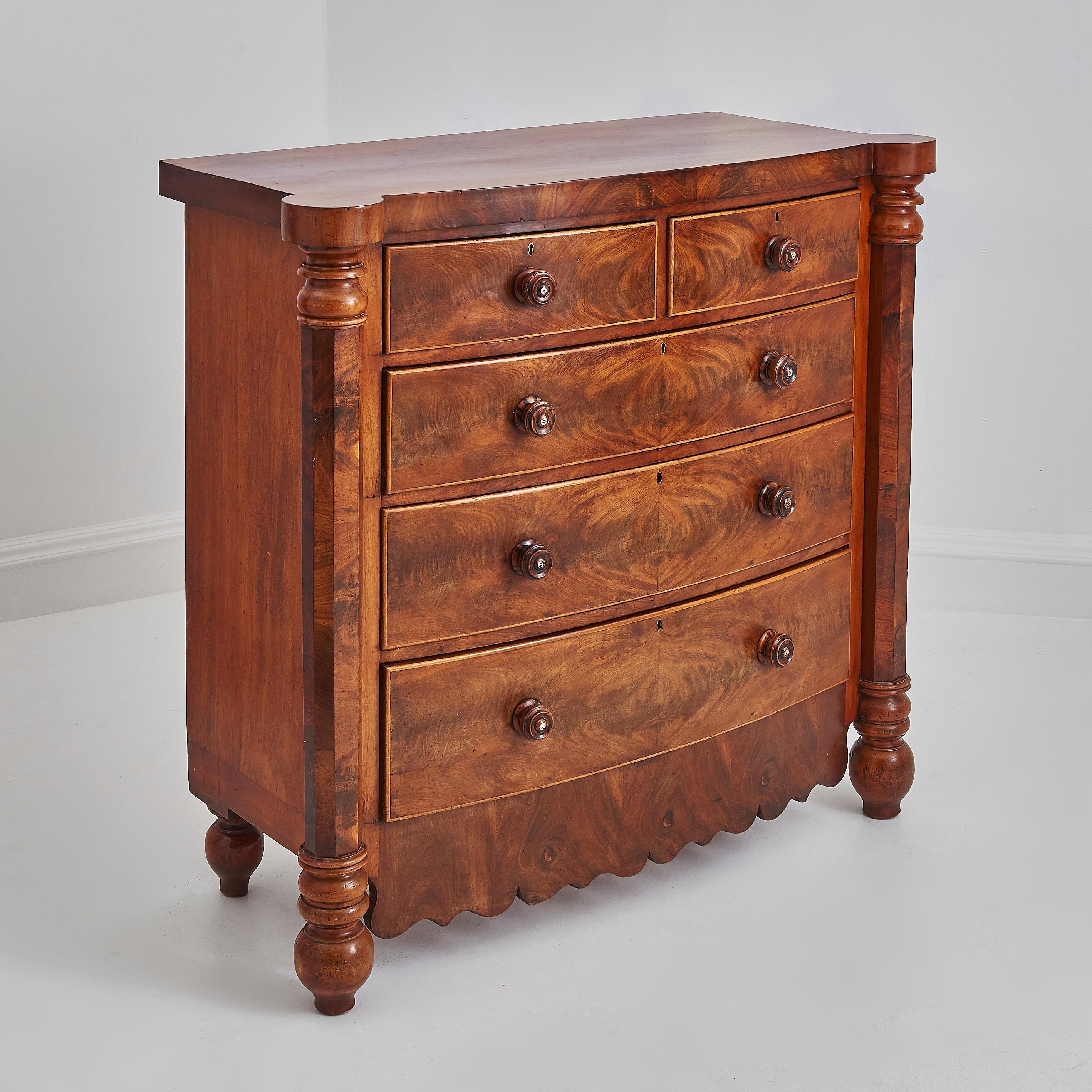 This beautifully crafted antique chest of drawers showcases timeless craftsmanship and classic design from the 19th century.  

Constructed from rich flame mahogany, this piece features a stunning grain pattern that has warmth and