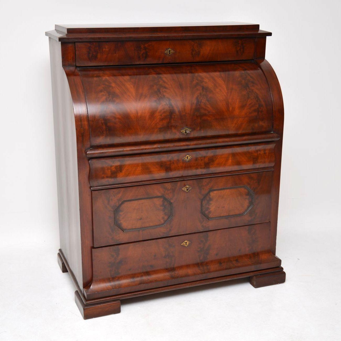 This antique mahogany cylinder top bureau is a spectacular piece of furniture and is in excellent condition. I believe it’s French and dates from around the 1840s period. Please enlarge all the images to see all the many fine details and see how the