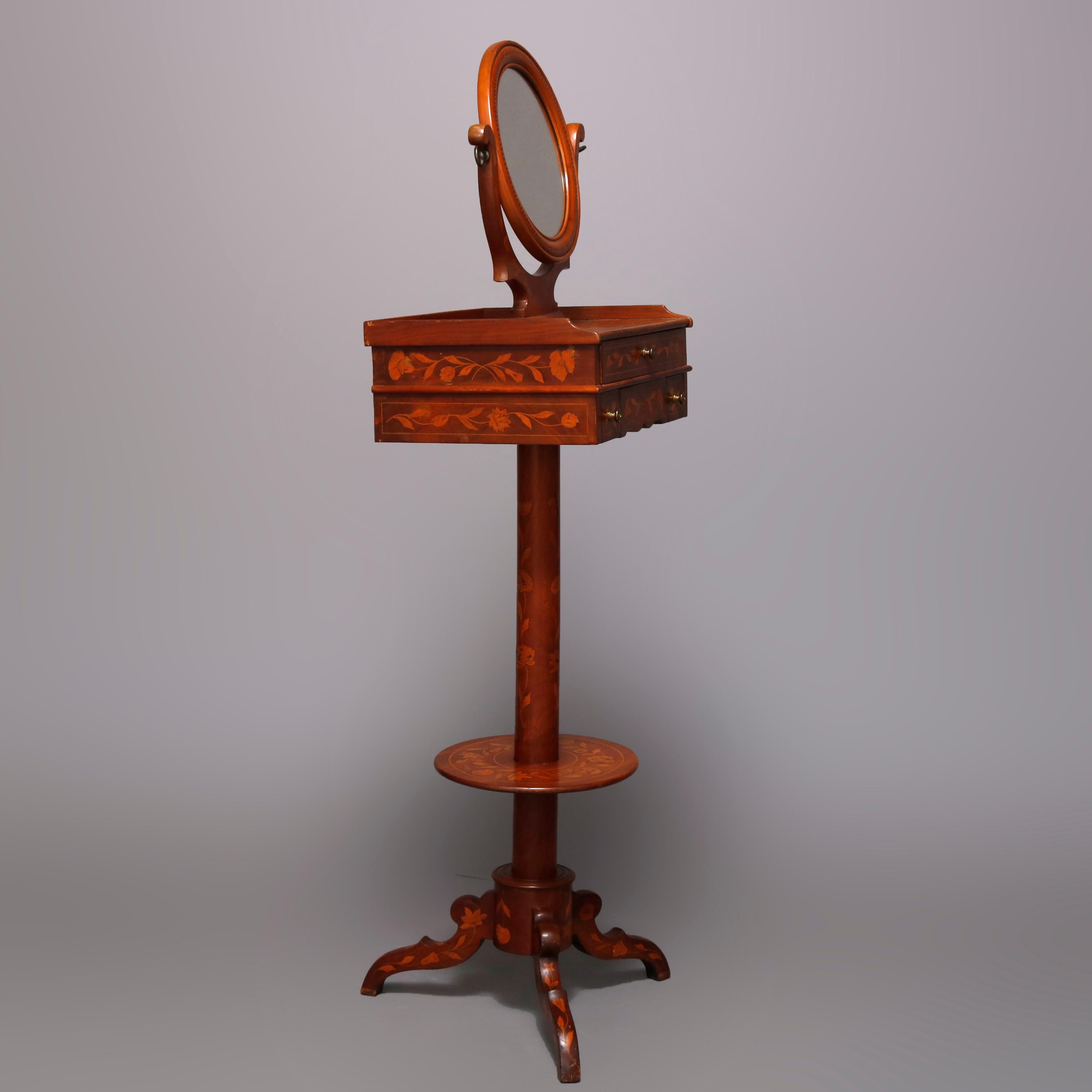 An antique Dutch marquetry telescoping shaving stand offers flame mahogany construction with swivel mirror surmounting pedestal having foliate inlaid two-drawer case raised on inlaid column having lower inlaid foot rest and raised on quadruped base,