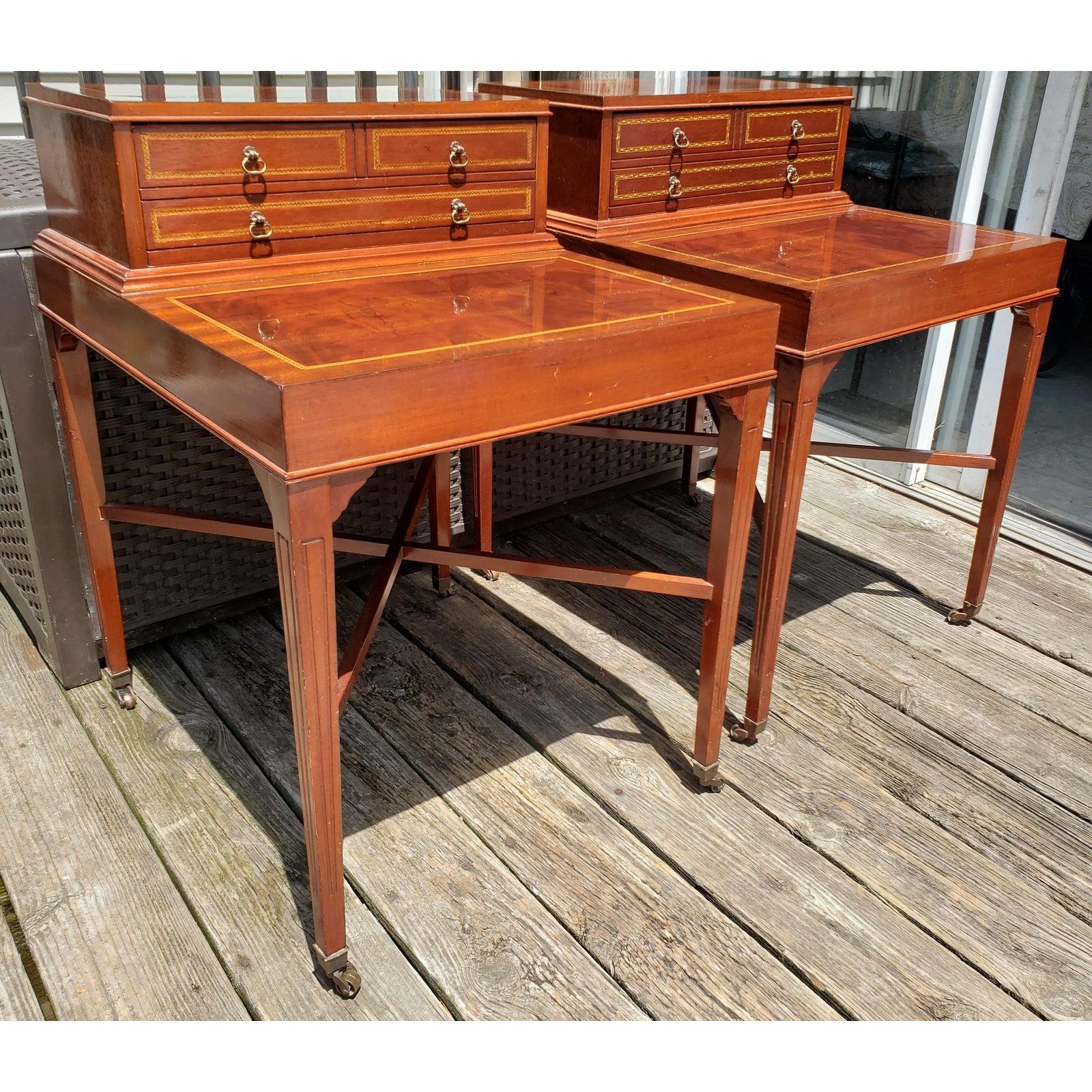 Antique Flame mahogany inlaid satinwood banded 2 tier side tables end tables. Brass capped feet over brass wheels. One oversized dovetailed drawer with 4 drawer pulls. Very sturdy pair of tables with cross bars underneath for greater stability. The