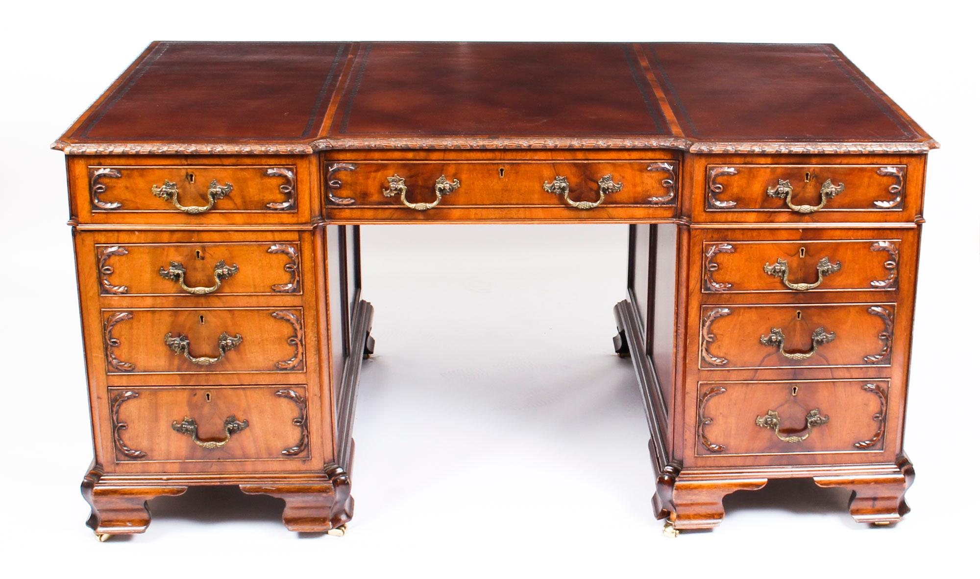 This is a wonderful antique flame mahogany twin pedestal partners desk in the stunning George III manner, circa 1870 in date.
 
The rectangular desk is of inverted breakfront outline and the top features an inset three part blind tooled tan leather